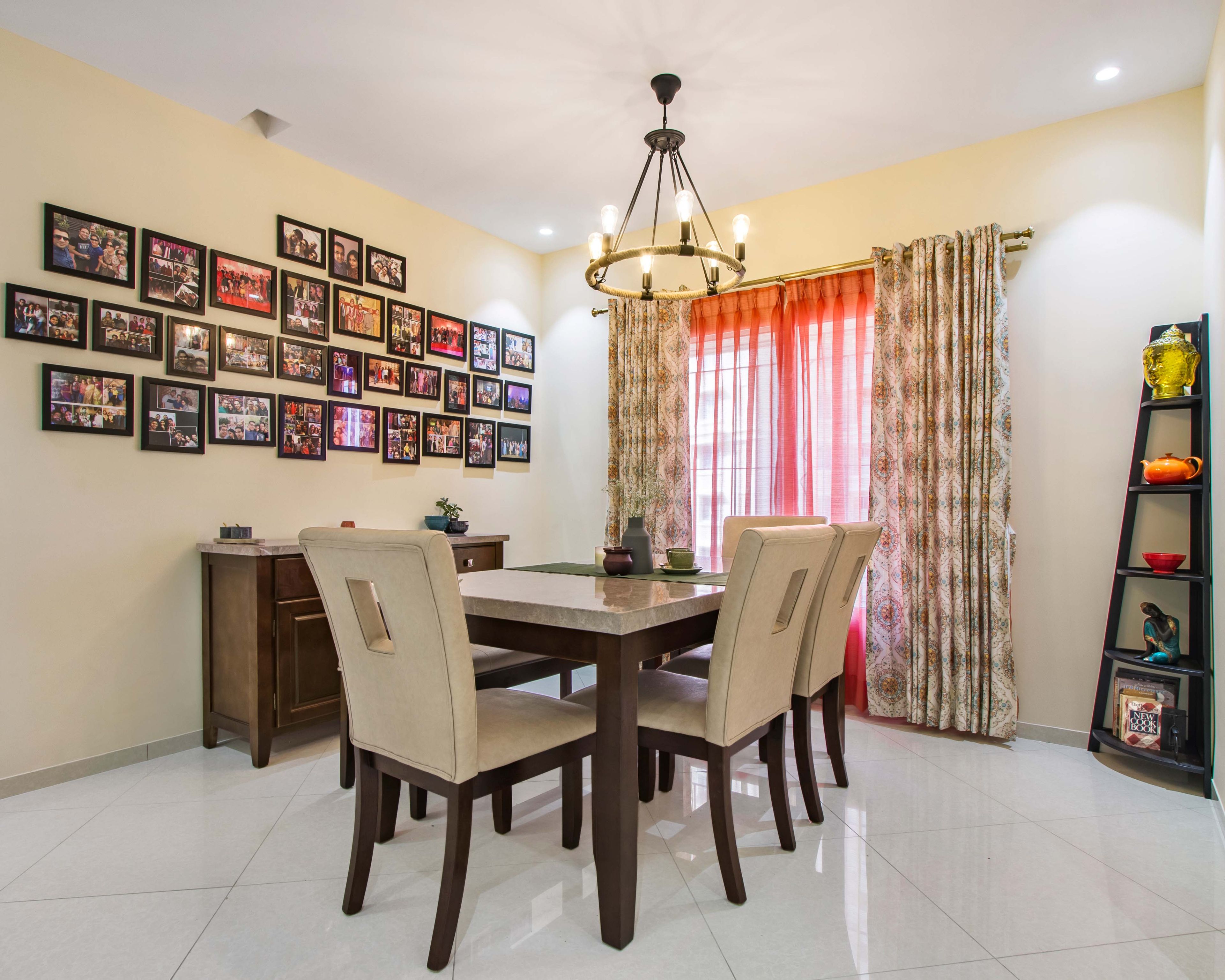 6-Seater Dining Room Design with Beige Upholstery, Hanging Lights and Photo Frames on Wall - Livspace