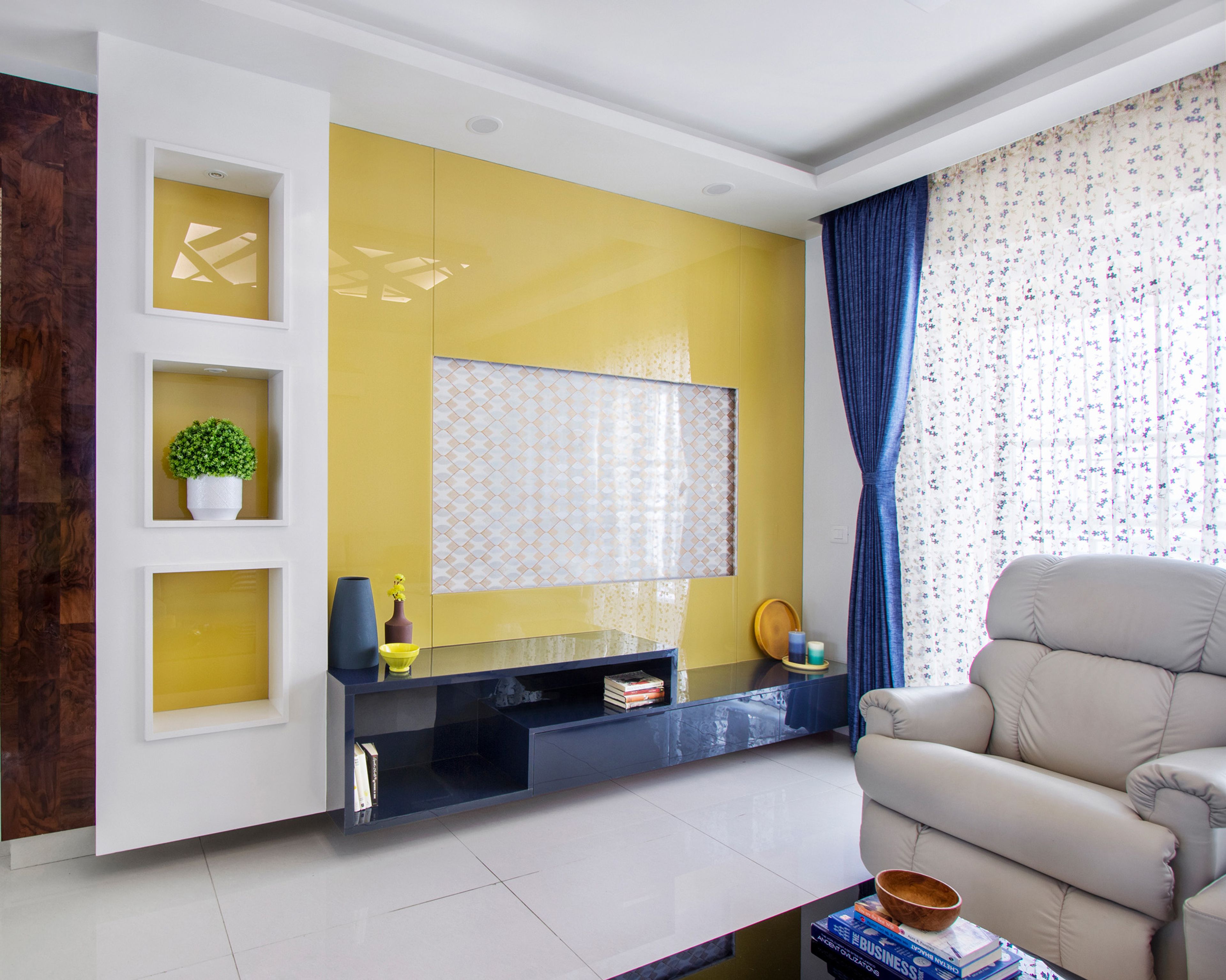 Living Room Design with Yellow Wall and Blue TV Unit