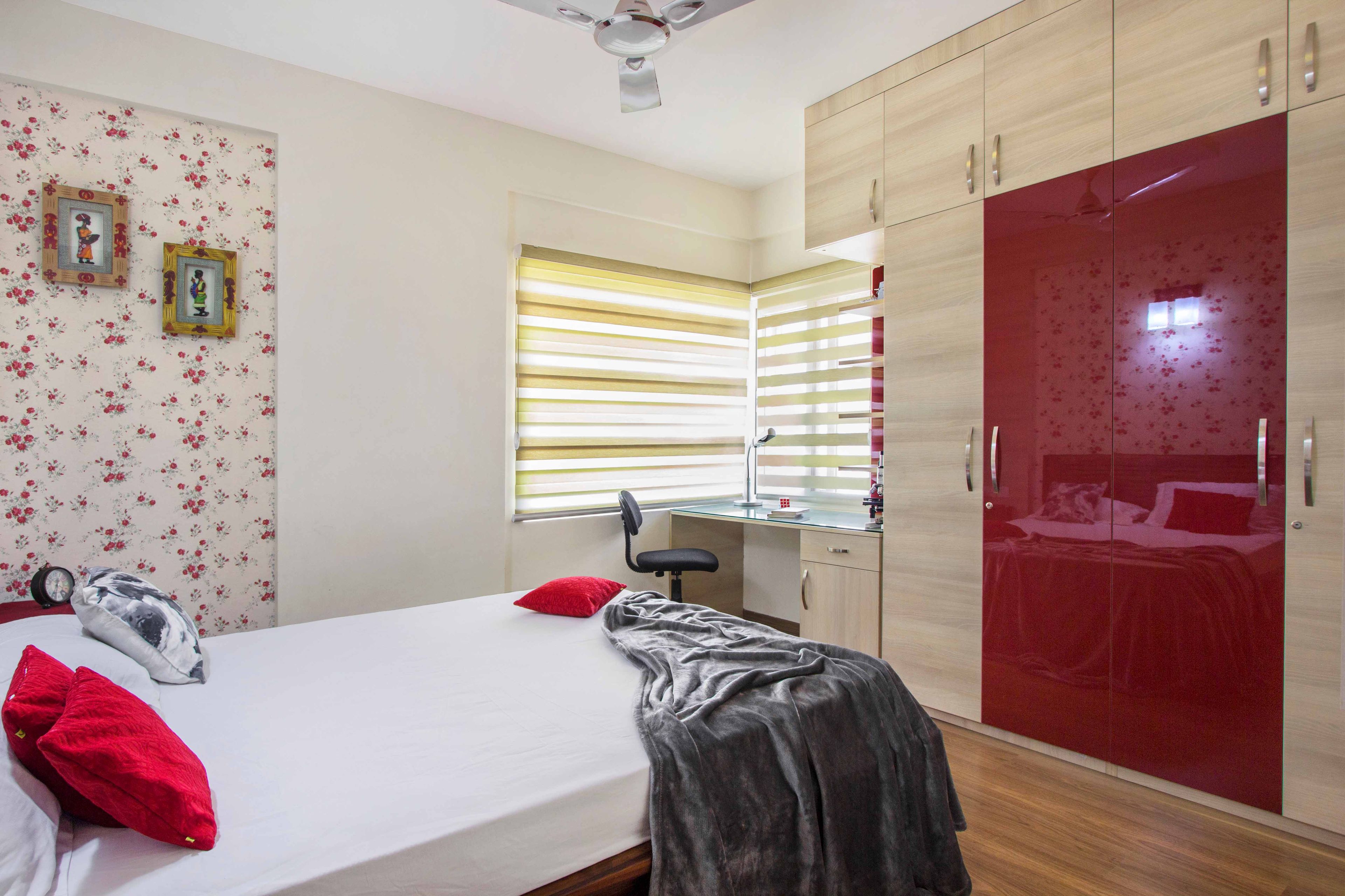 Master Bedroom Design with 4-Door Maroon and Wooden Swing Wardrobe and Study Space - Livspace