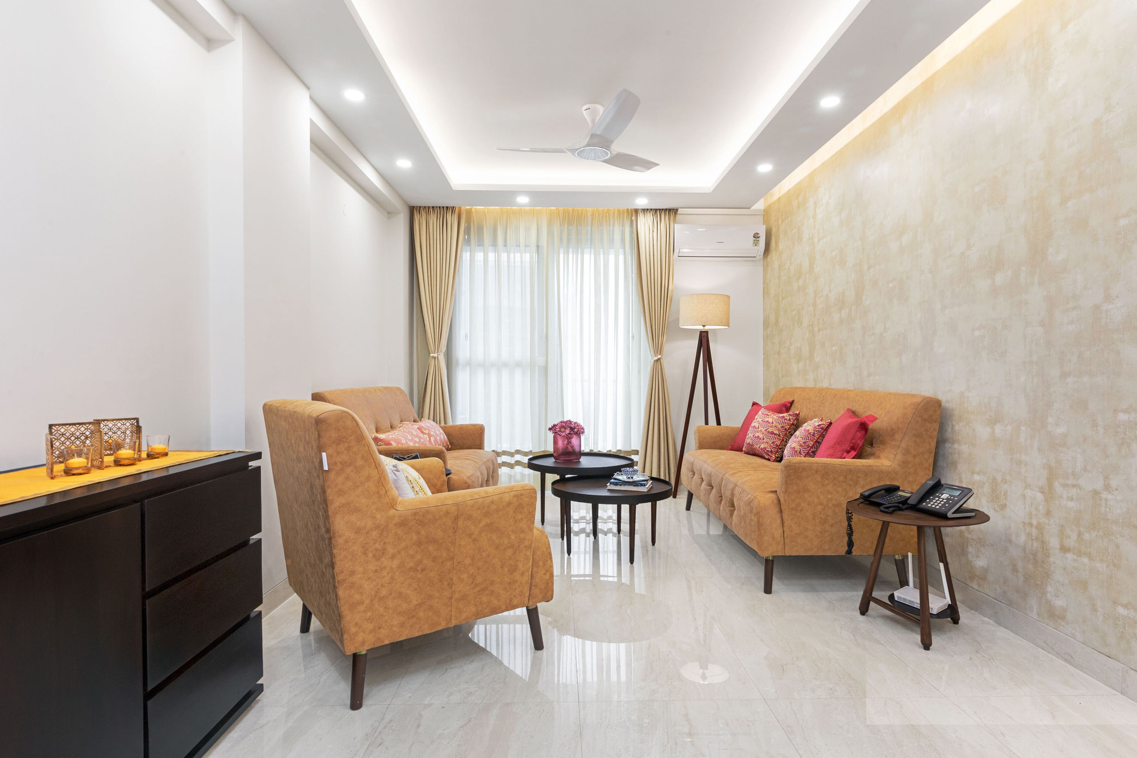 Spacious Living Room With Light Brown Sofas And Nesting Coffee Table - Livspace