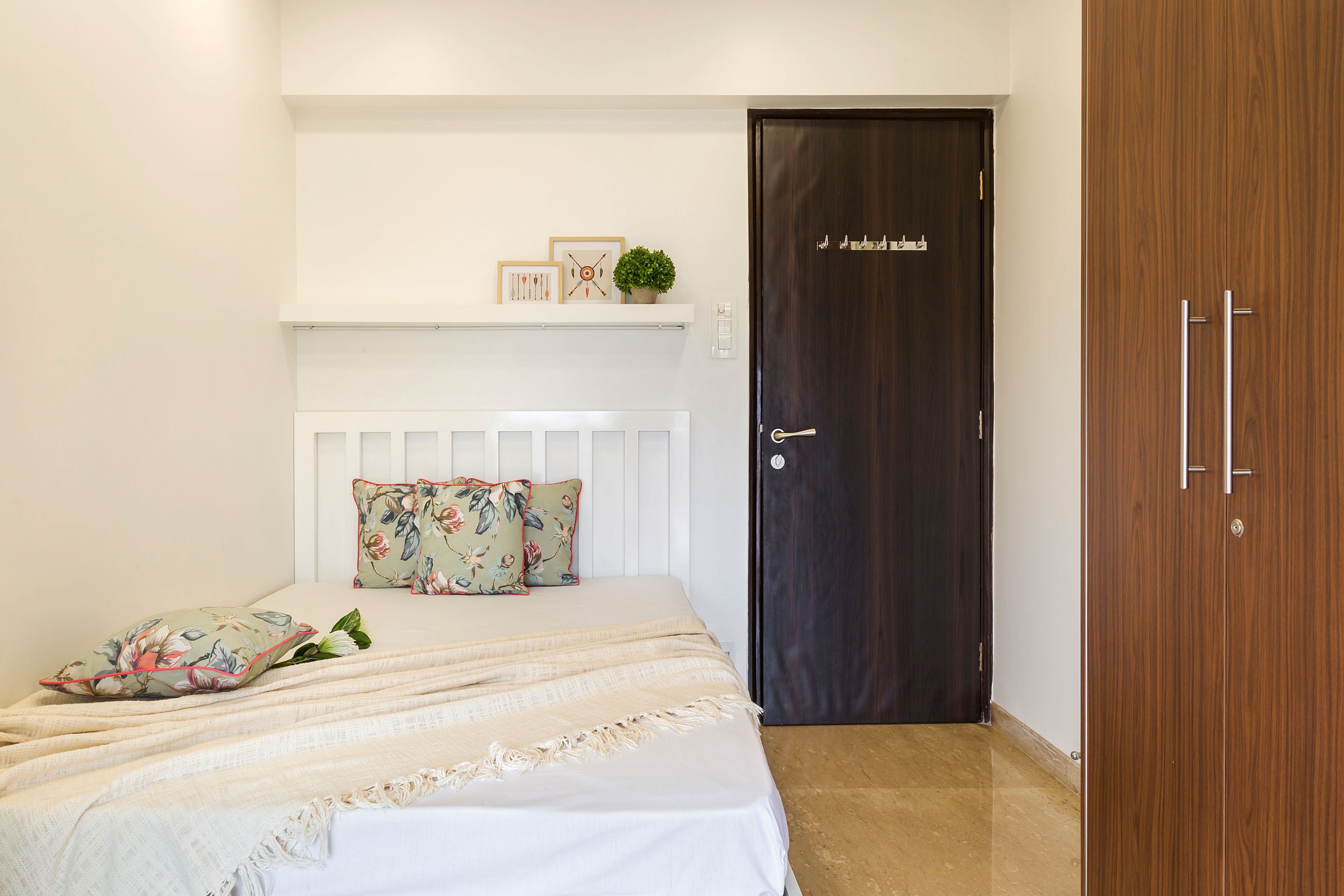 Minimal Kids Room Design With White Single Bed And 2-Door Wooden Wardrobe