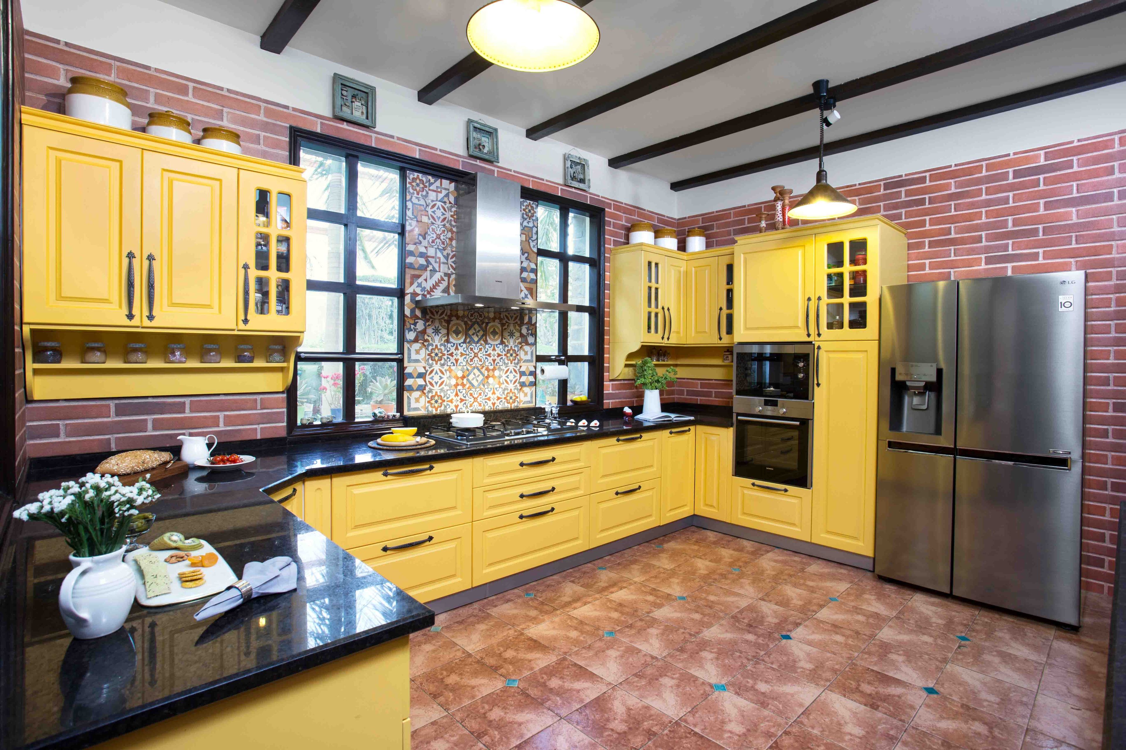 U-Shaped Yellow Transitional Kitchen Design With Brown Ceramic Flooring, Refrigerator, Red Brick Tiles And Moroccan Dado Tiles - Livspace
