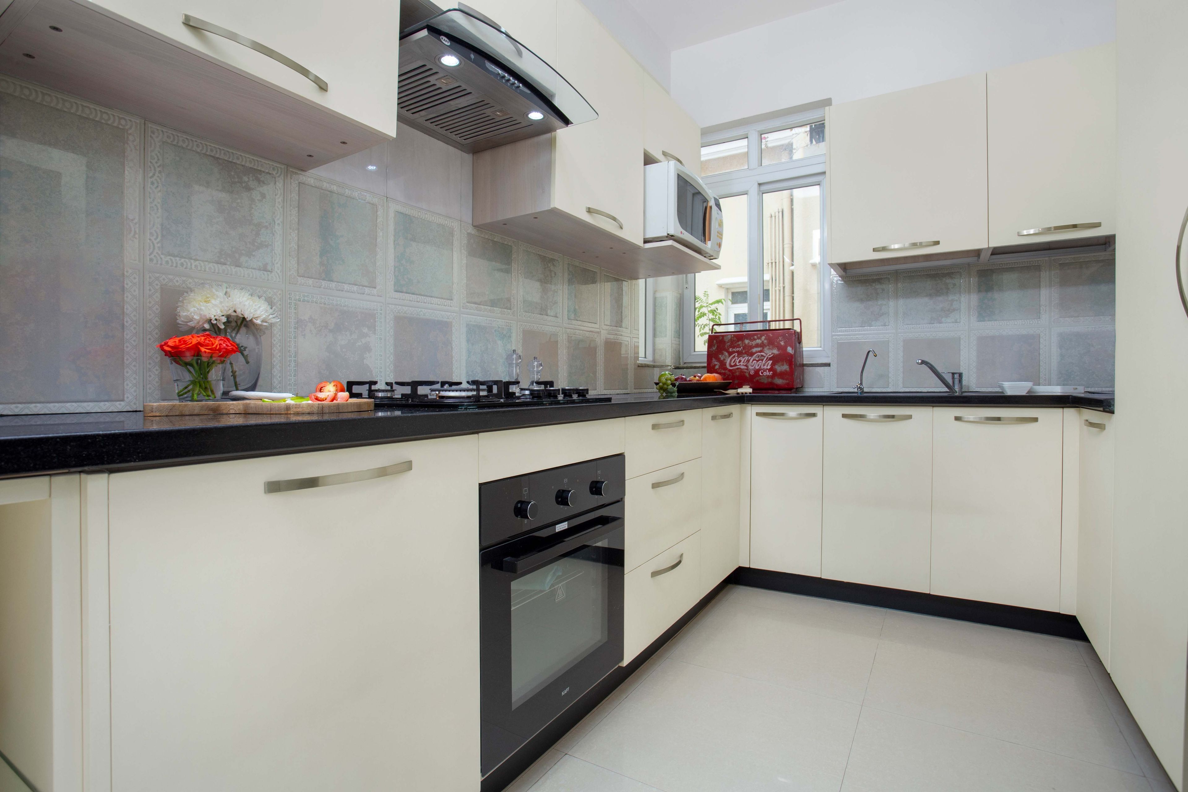 Contemporary Modular Champagne Toned U-Shaped Kitchen Cabinet Design With Beveled Pastel-Toned Backsplash