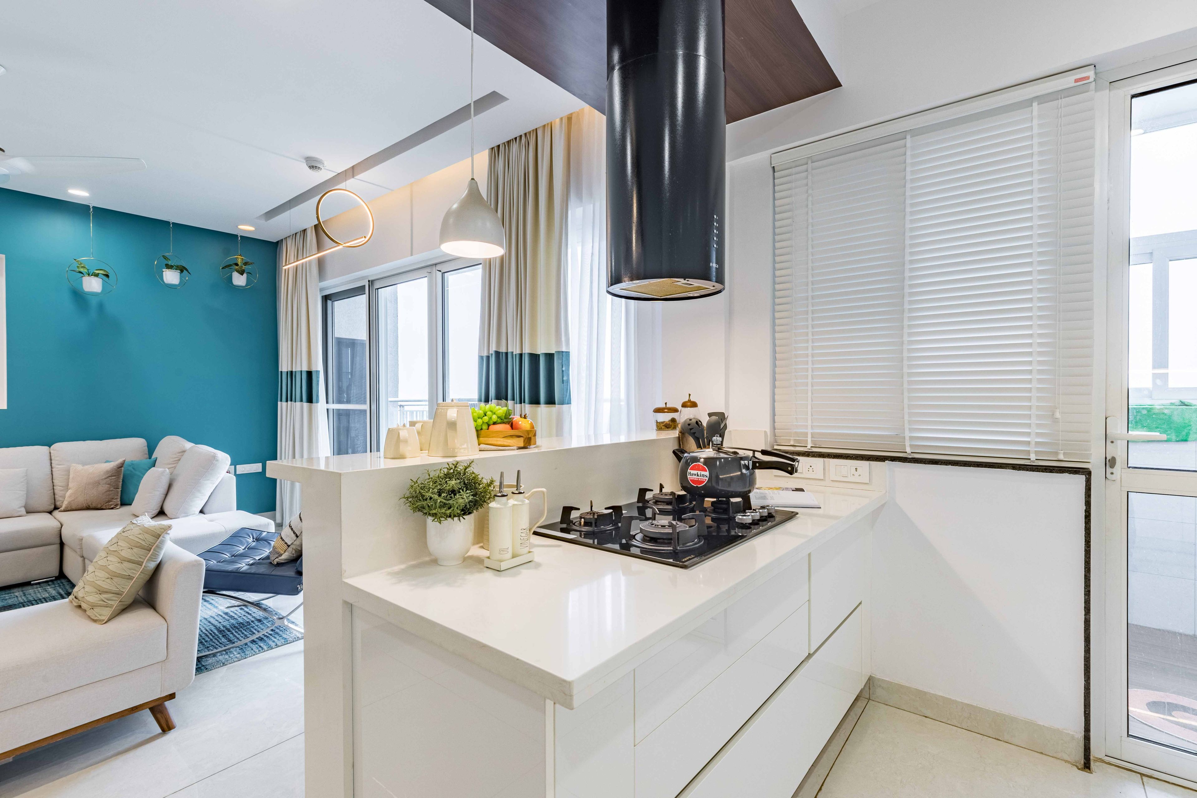 White Kitchen Countertop With Breakfast Counter And Open White And Blue Living Room Plan - Livspace