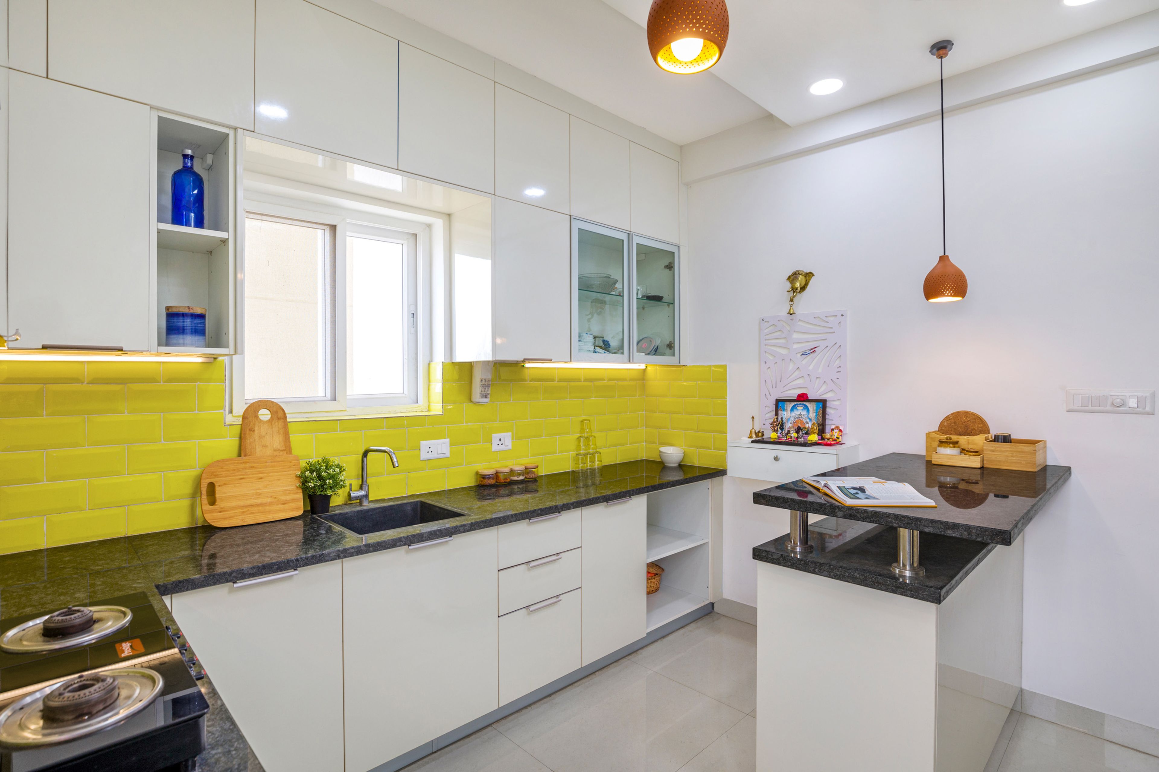 White Indian Kitchen Design With Granite Countertop And Yellow Dado Tiles - Livspace