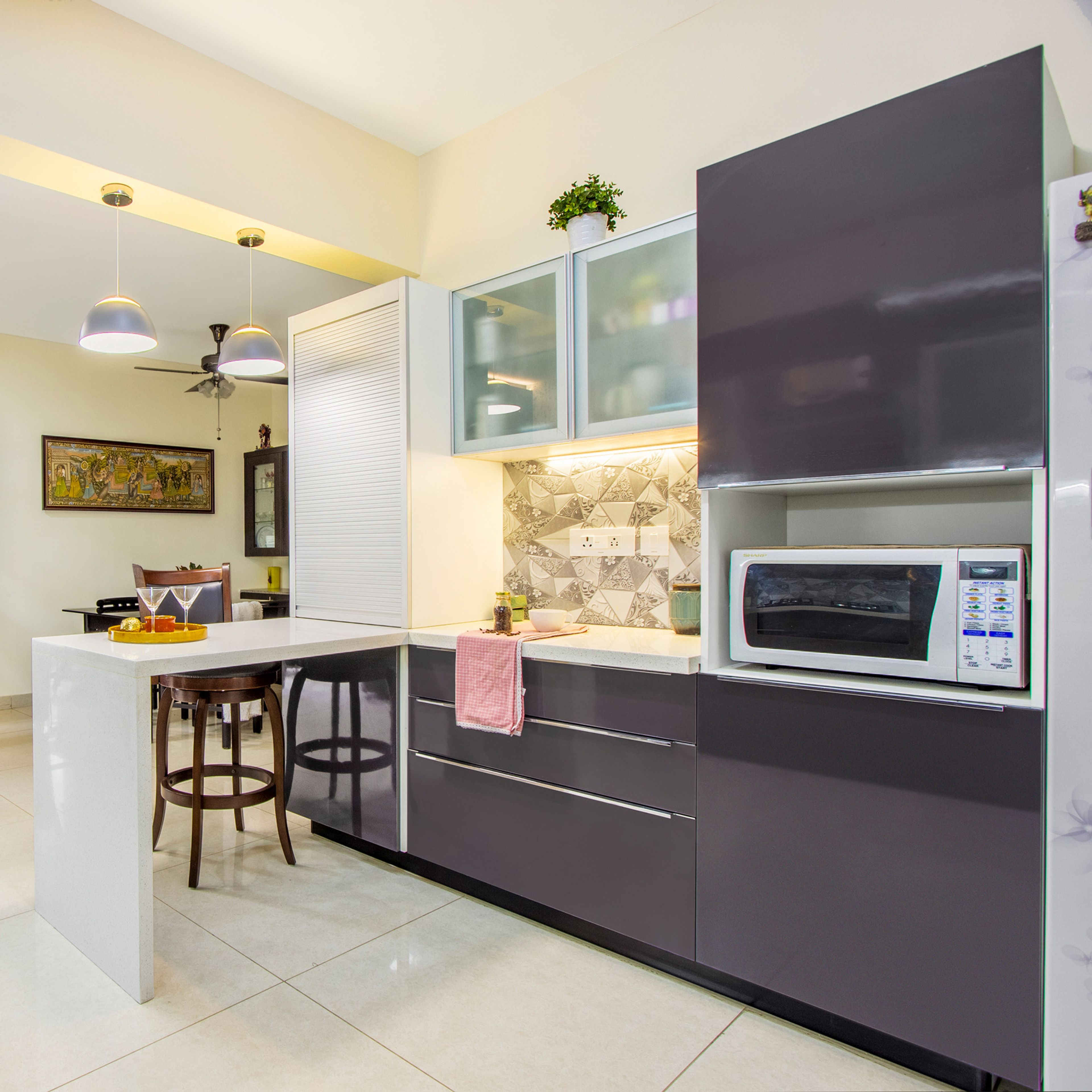 Gothic Grey Kitchen Cabinet Design With White Breakfast Counter And Geometric Abstract Dado Tiles - Livspace