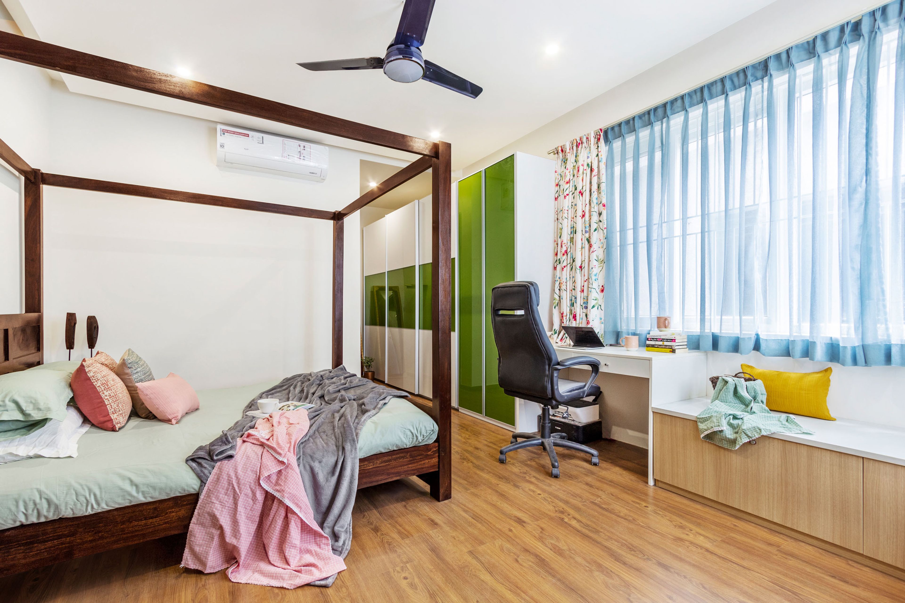 Master Bedroom With 5-Door Green And White Sliding-Swing Wardrobe, Wood And White Study Table And Storage Unit- Livspace