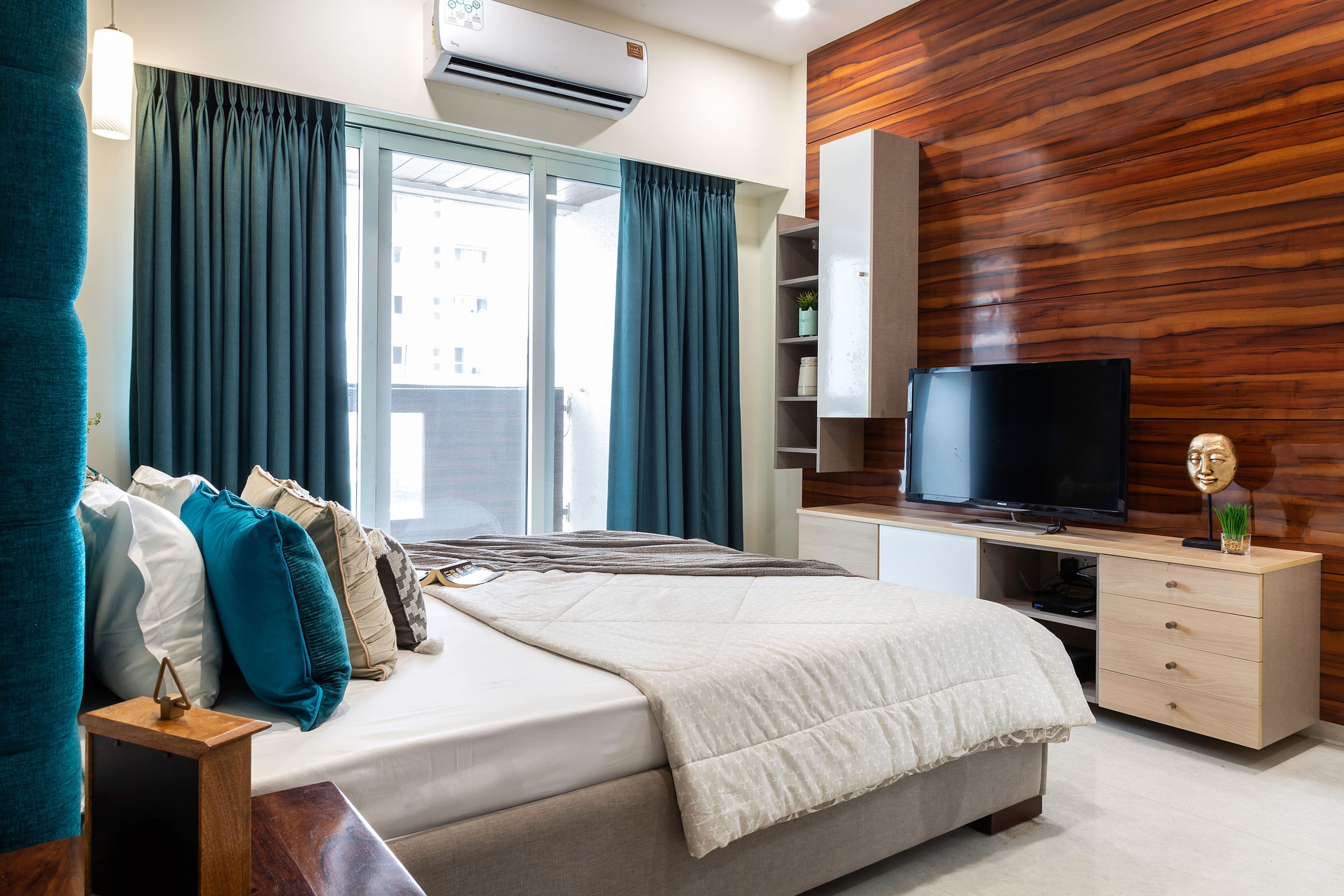 Master Bedroom With Floor-Mounted Wood And White TV Unit Against Wooden Accent Wall And Wall-Mounted Storage Unit - Livspace