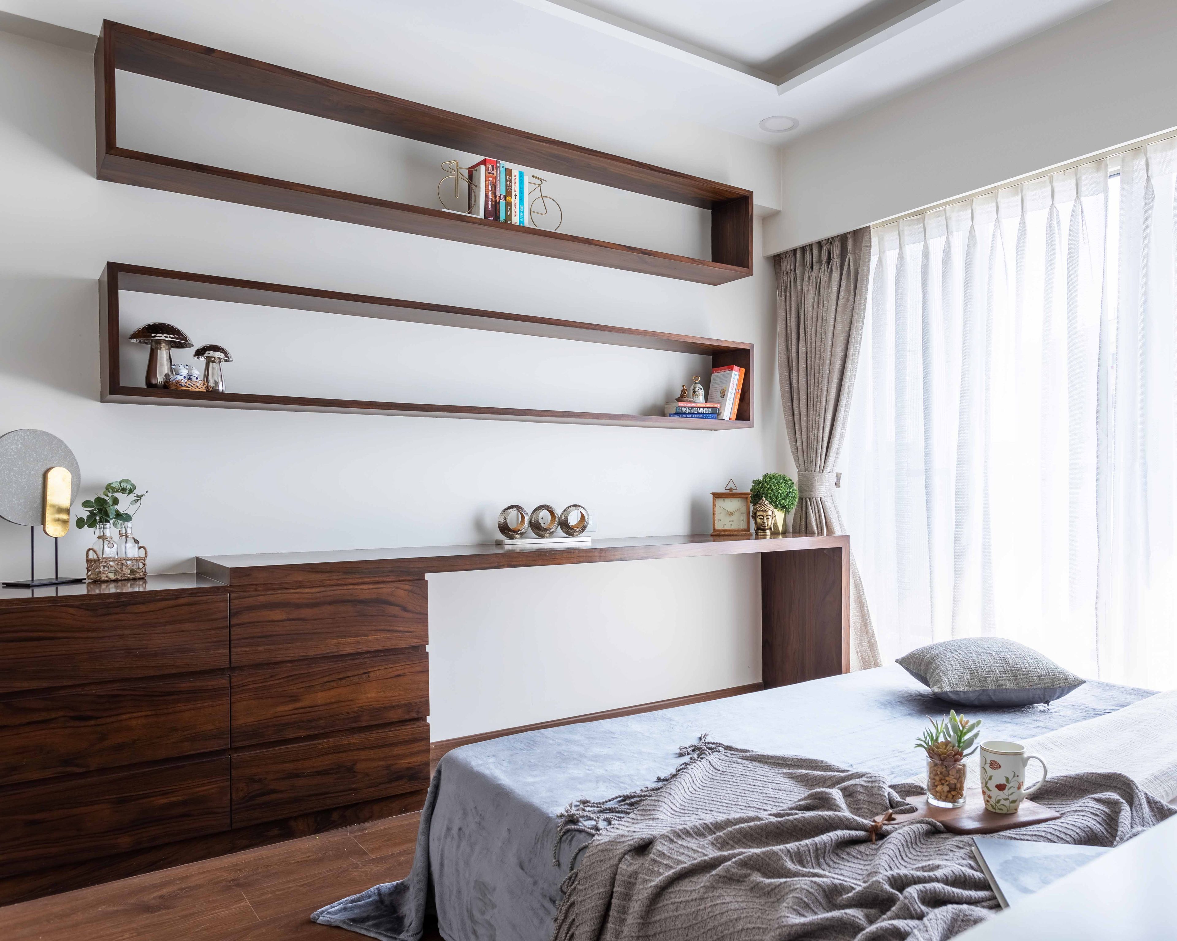 Master Bedroom With Spacious Wooden Storage Unit And Wall-Mounted Shelves - Livspace