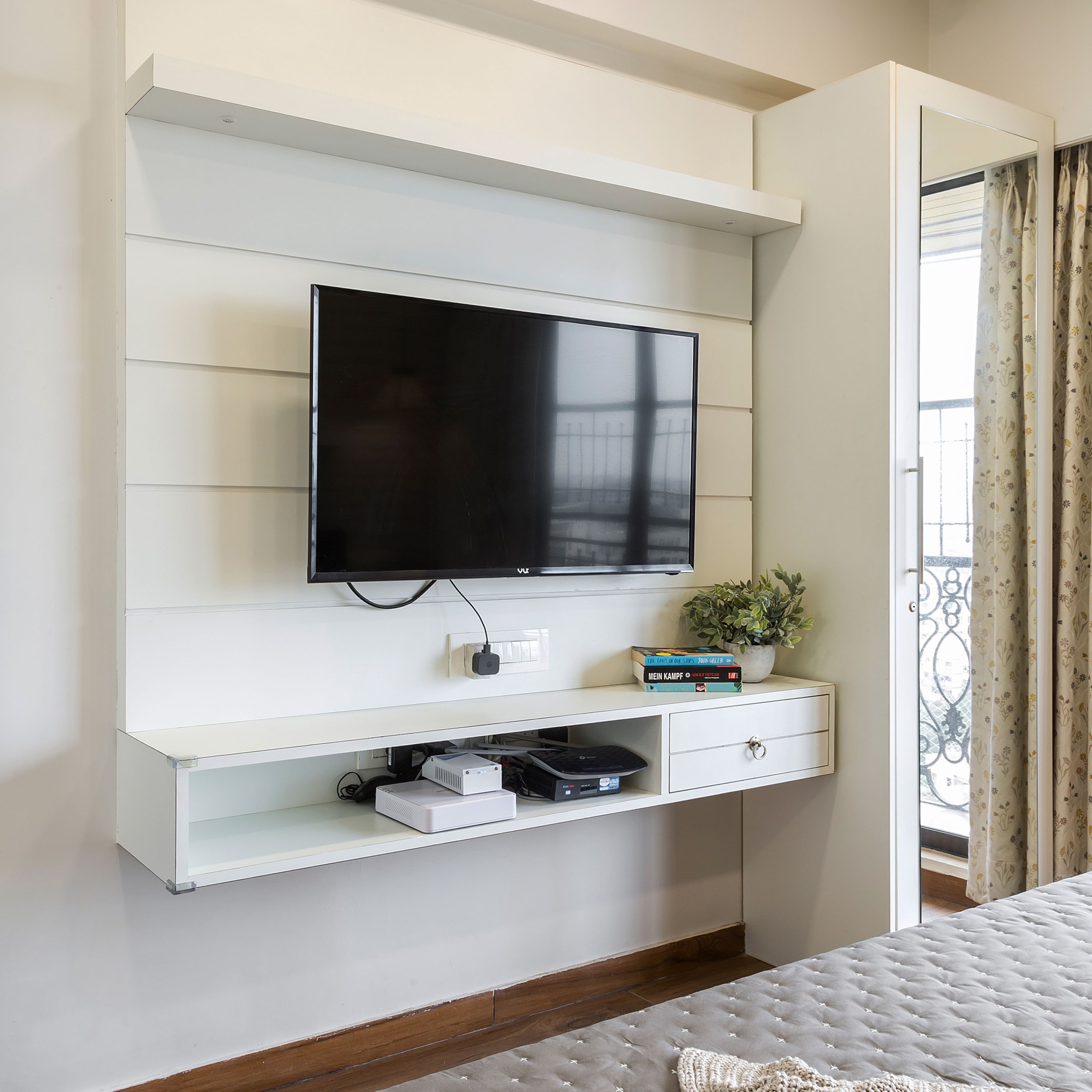 Master Bedroom With White Wall-Mounted TV Unit - Livspace