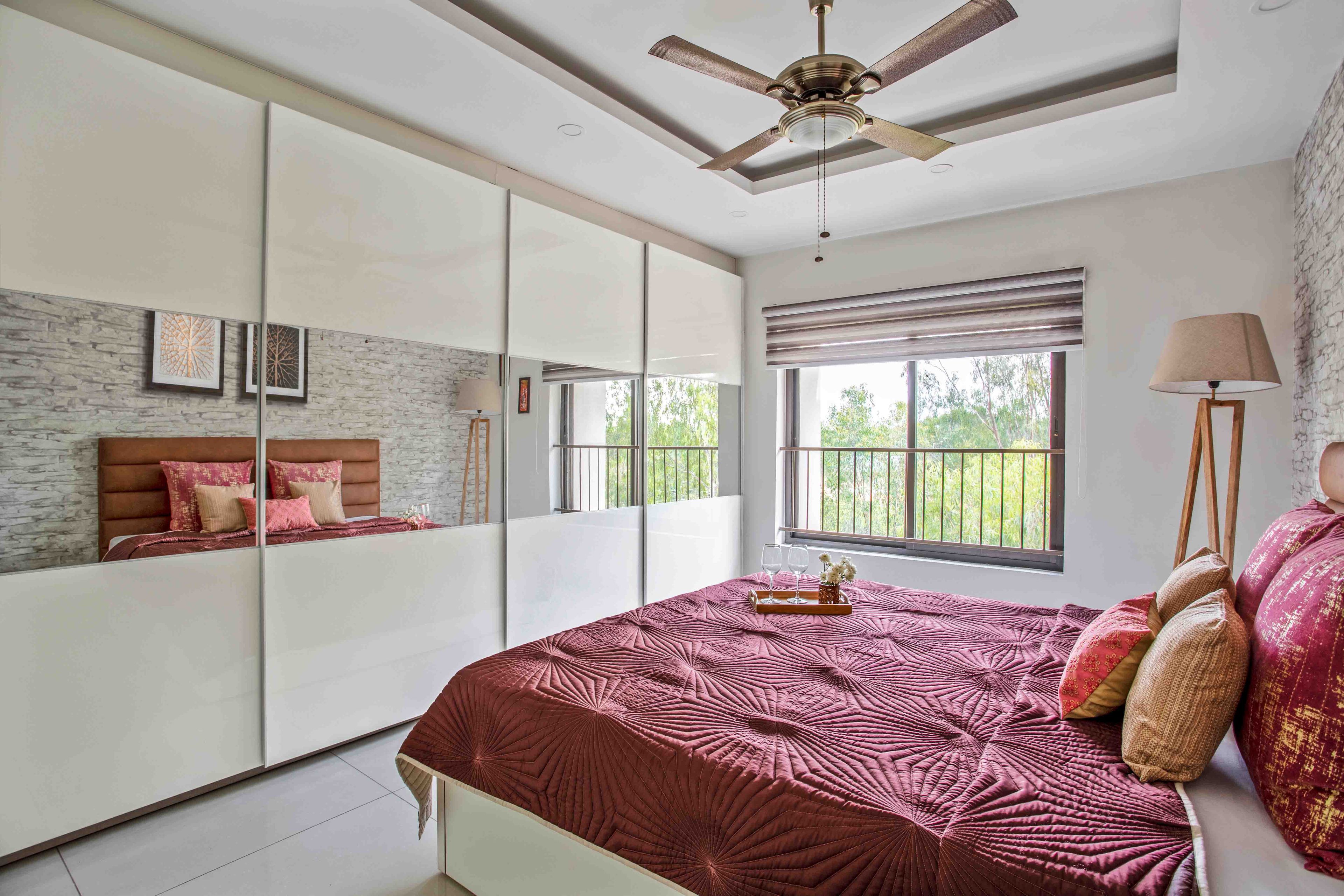 Master Bedroom With 4-Door Off-White Sliding Wardrobe And Mirrors - Livspace