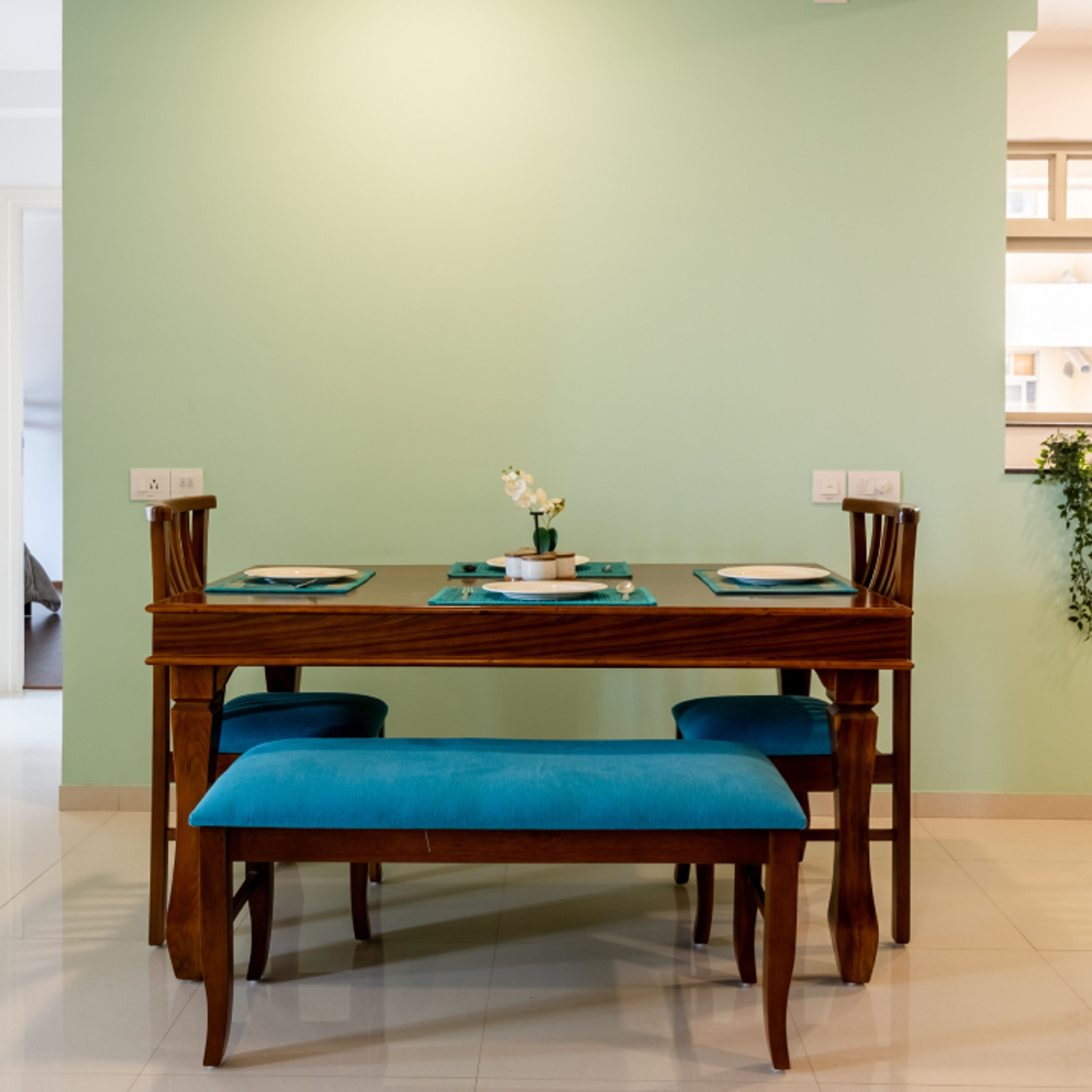 4-Seater Dining Room Design With A Wooden Table And Blue Cushioned Seating - Livspace
