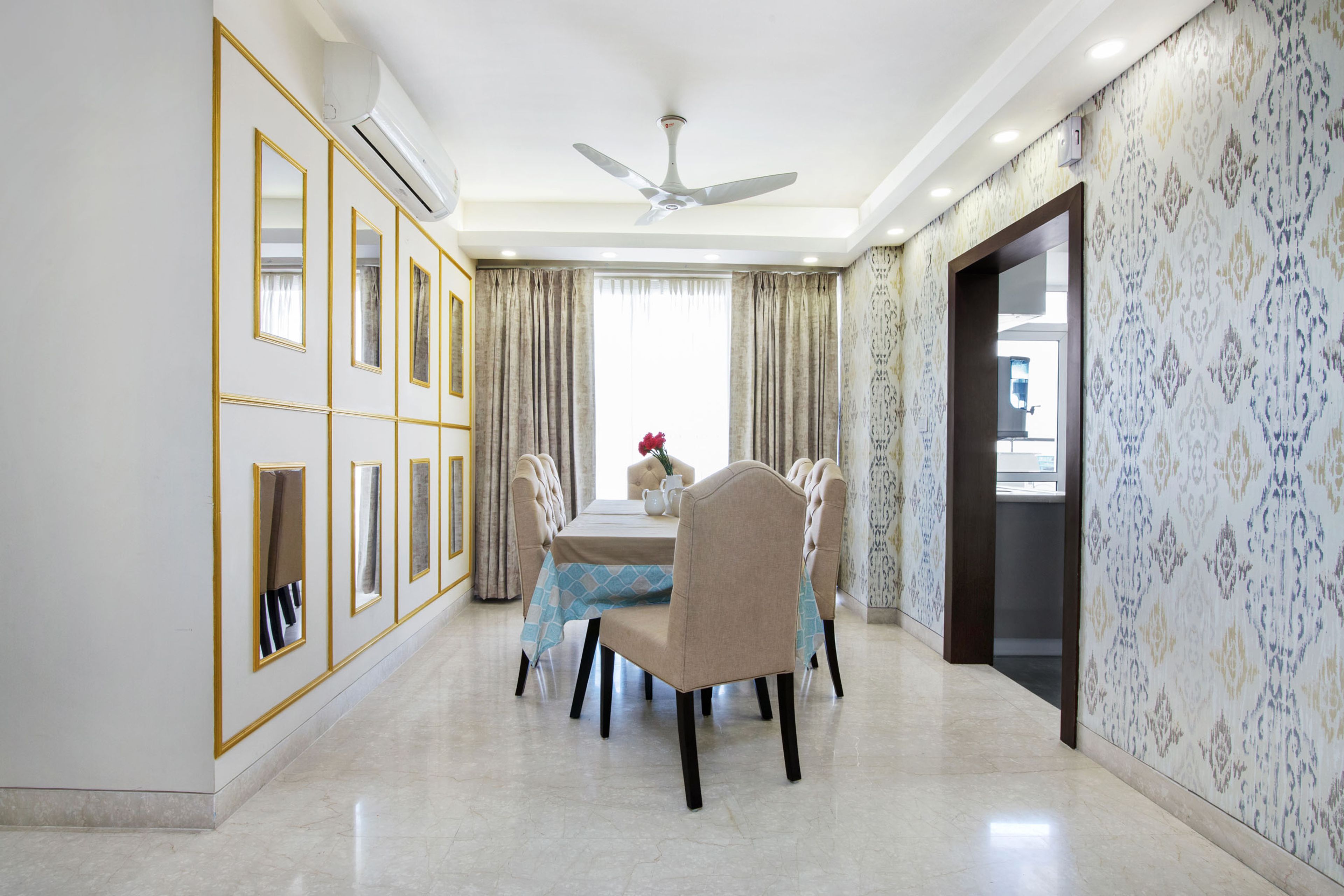 Contemporary 6-Seater Beige Dining Room Design With Mirrored Accent Wall