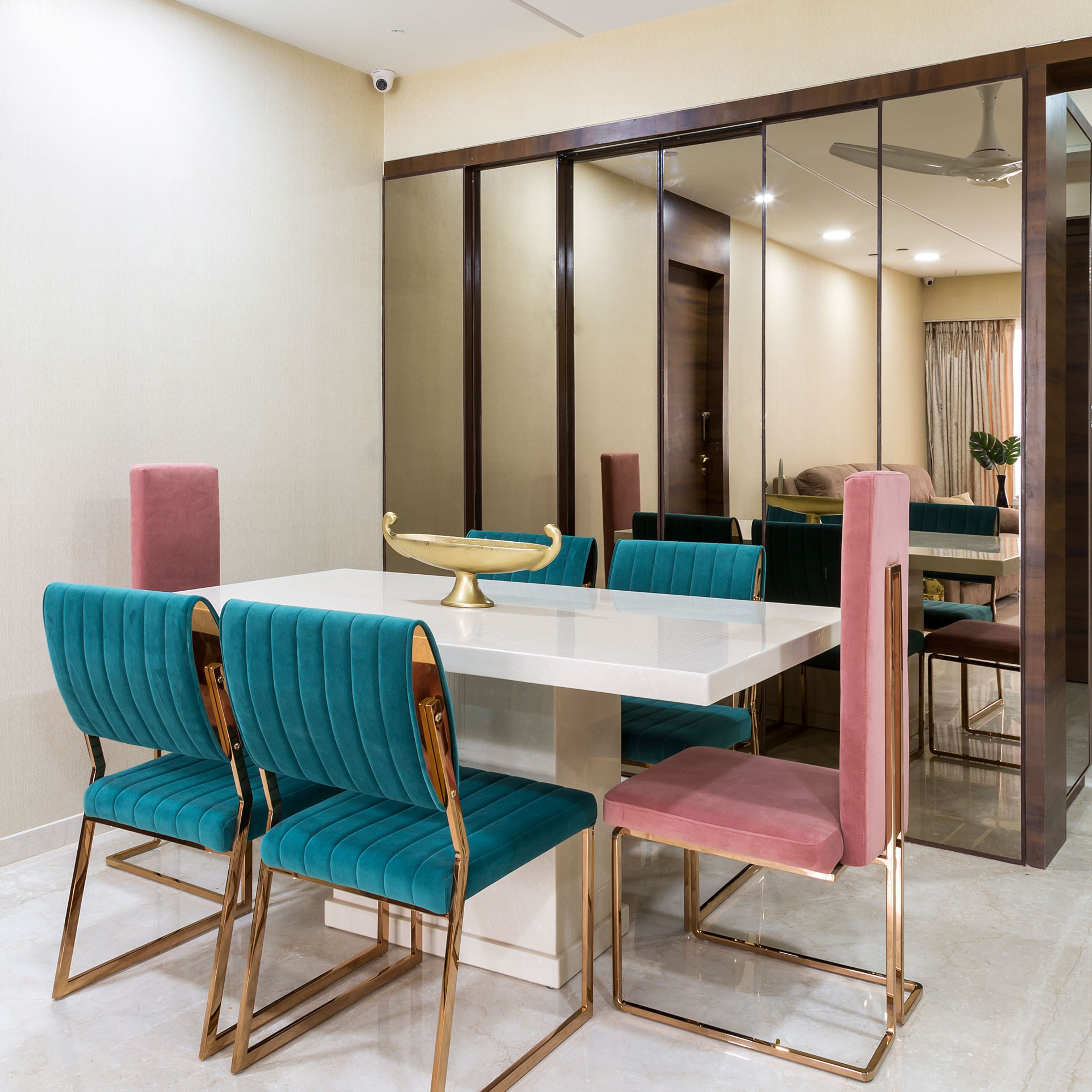 Modern Dining Room Design With Teal Blue And Pink Chairs
