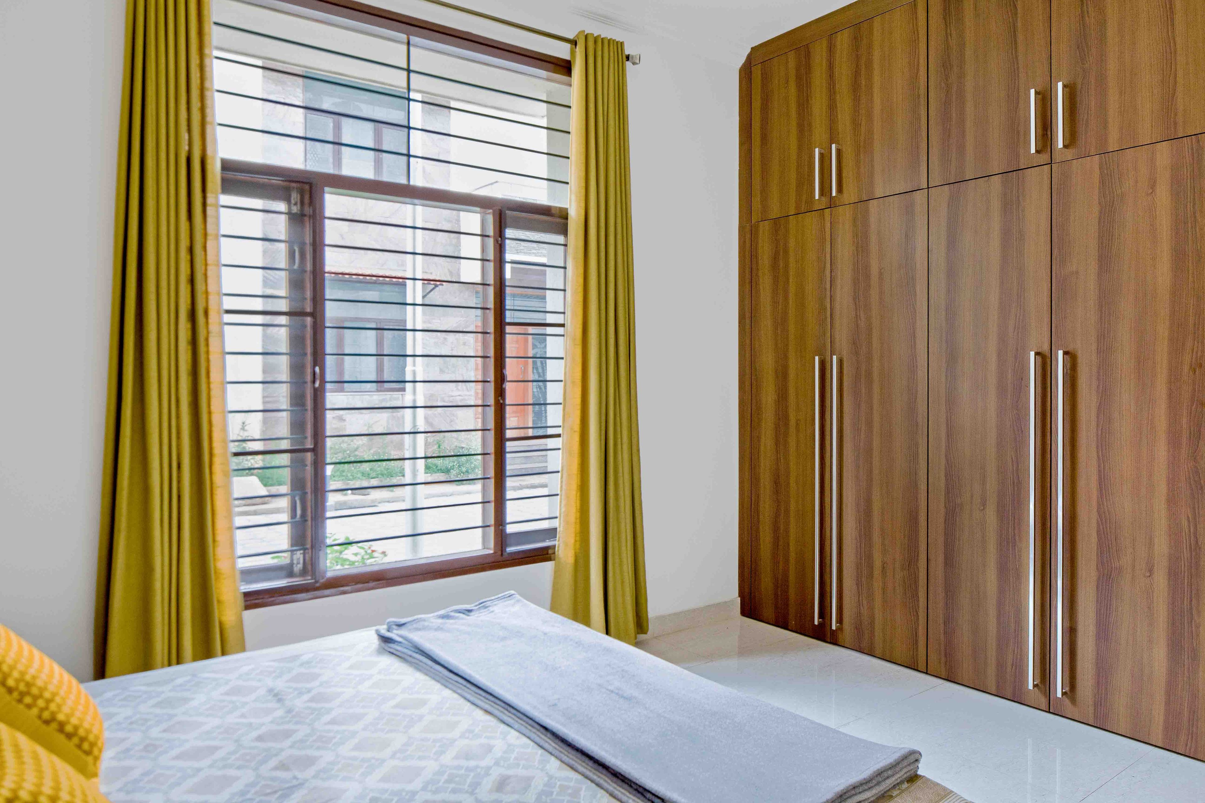 Guest Room Design In Brown And Yellow - Livspace