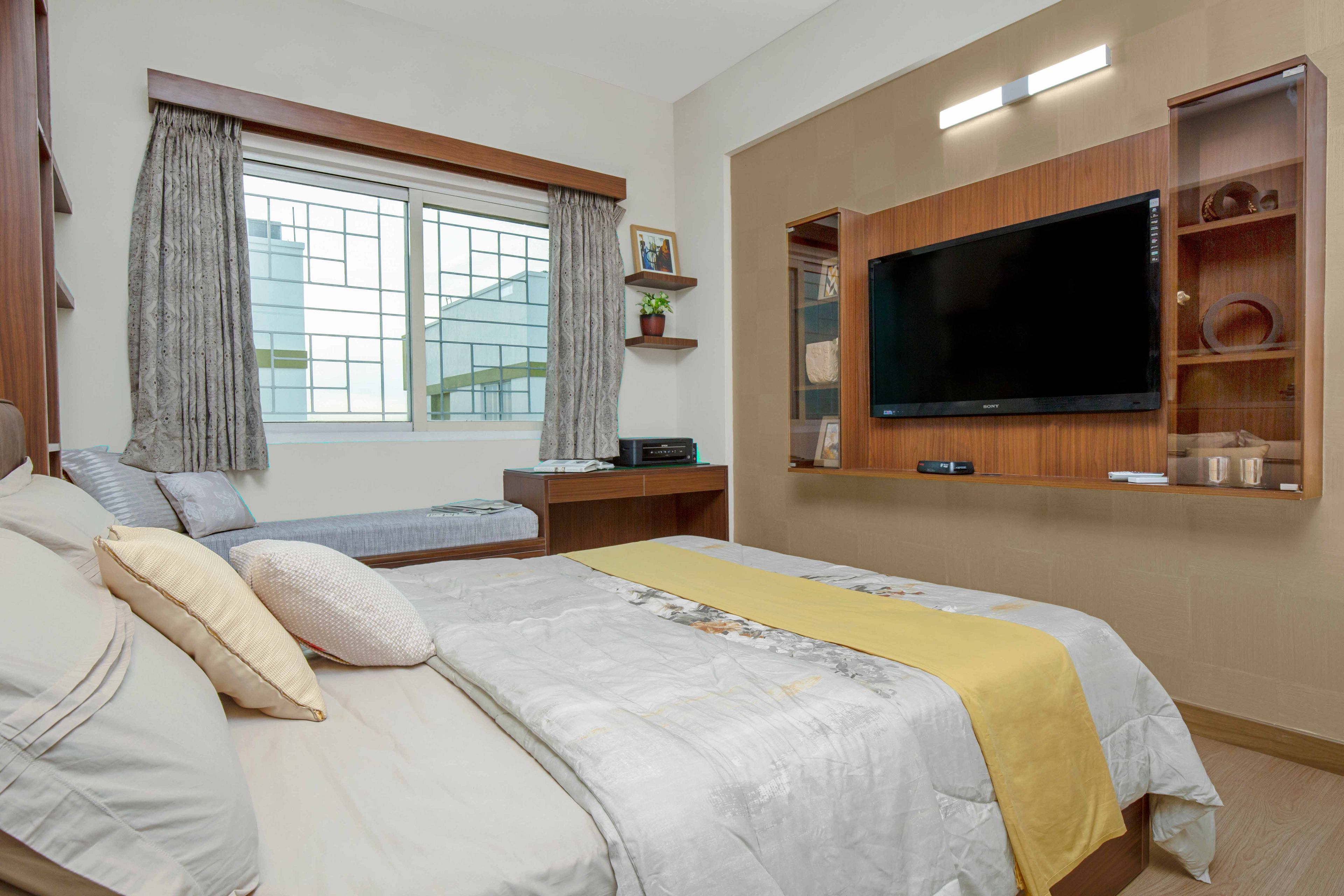 Guest Room Design With Wooden Bed Back Wall - Livspace