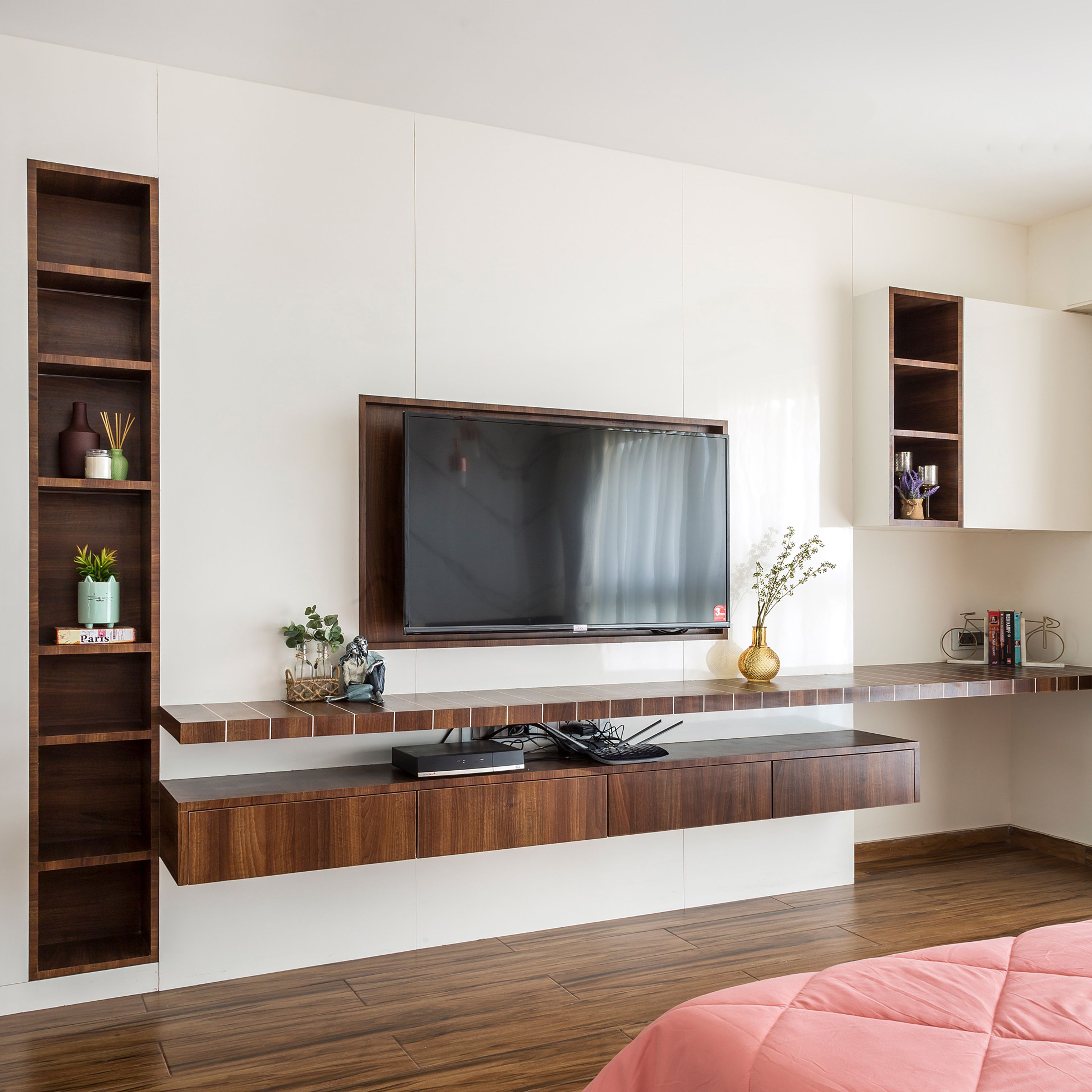 Wooden floating TV unit design with open storage units - Livspace