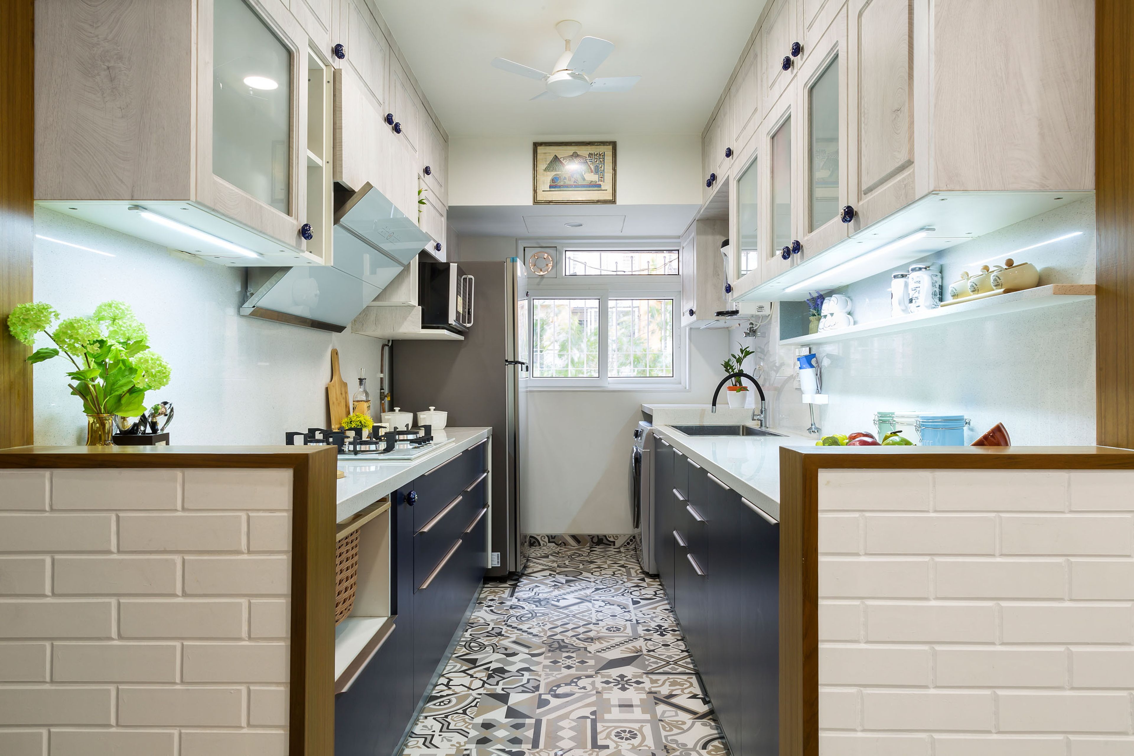 Parallel blue and white kitchen design with patterned flooring - Livspace