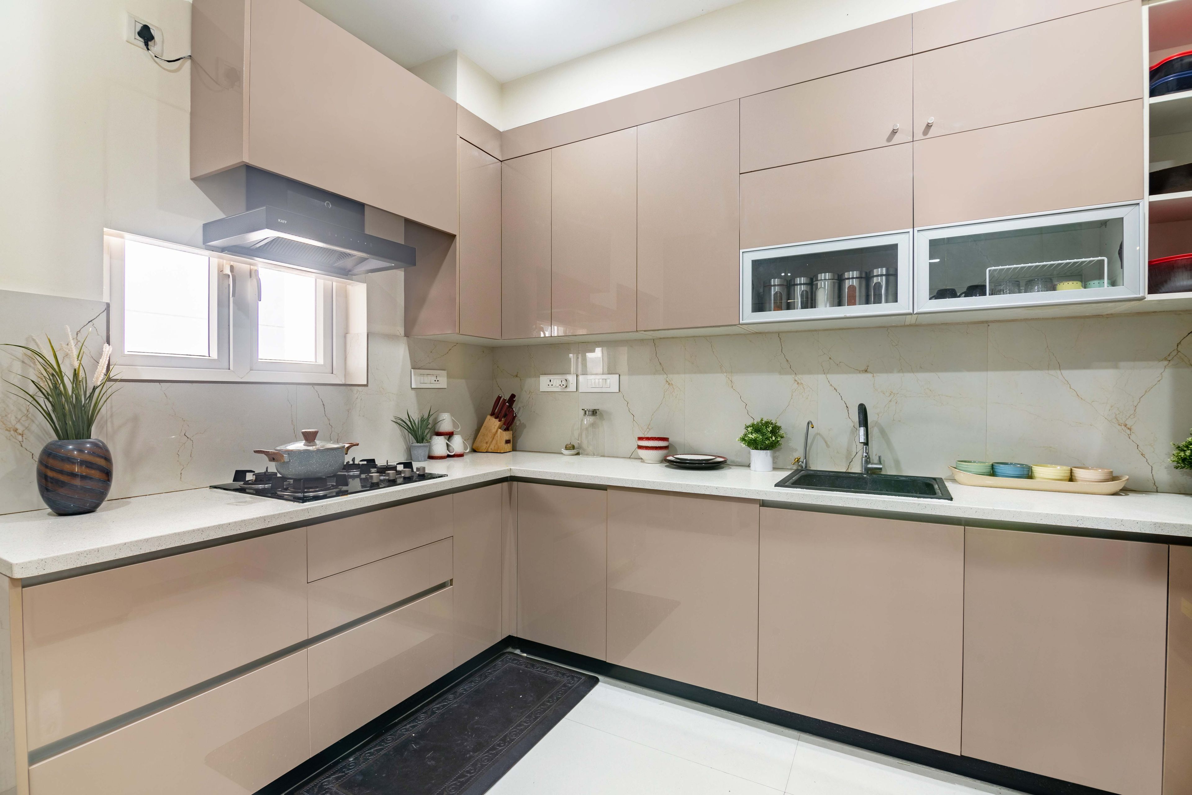 L shape beige kitchen with marble backsplash - Livspace