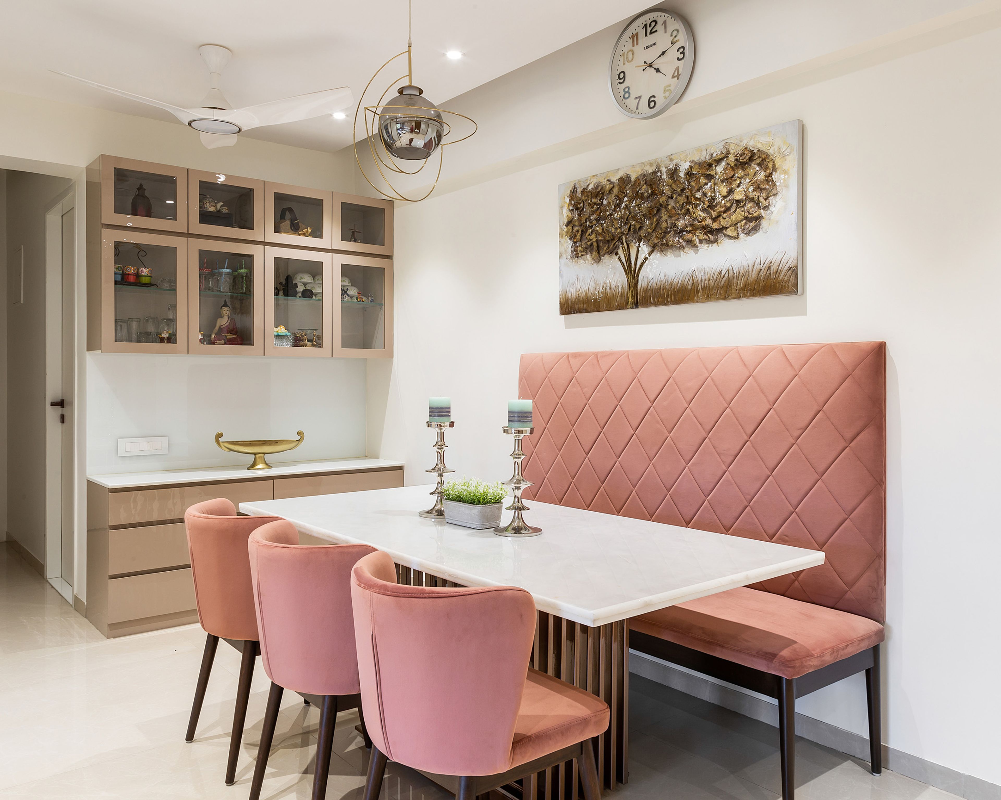 6-seater dining table with marble countertop and peach-coloured armless cushioned chairs - Livspace