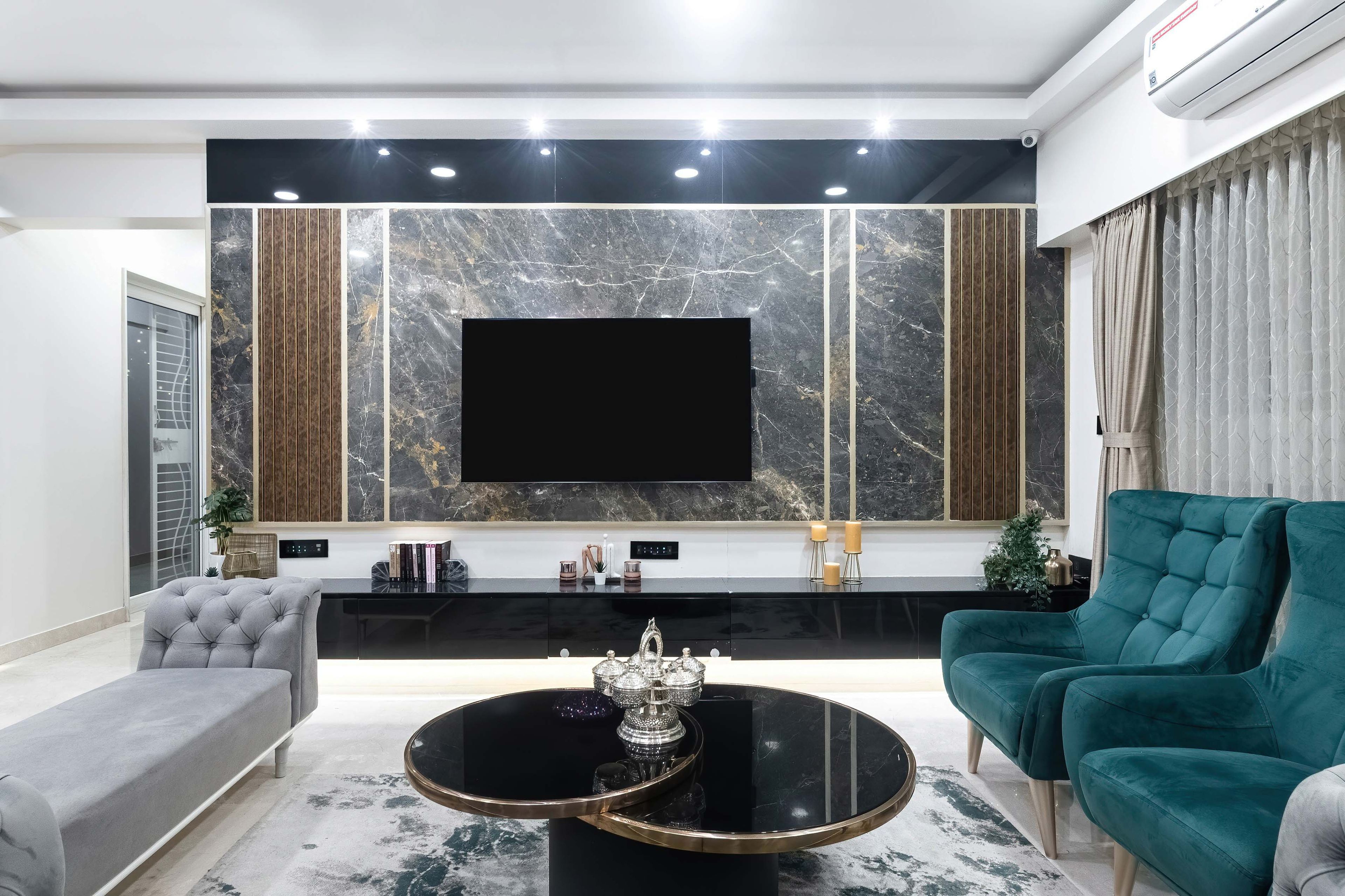 Teal blue and grey living room design with dark marble TV wall panel - Livspace