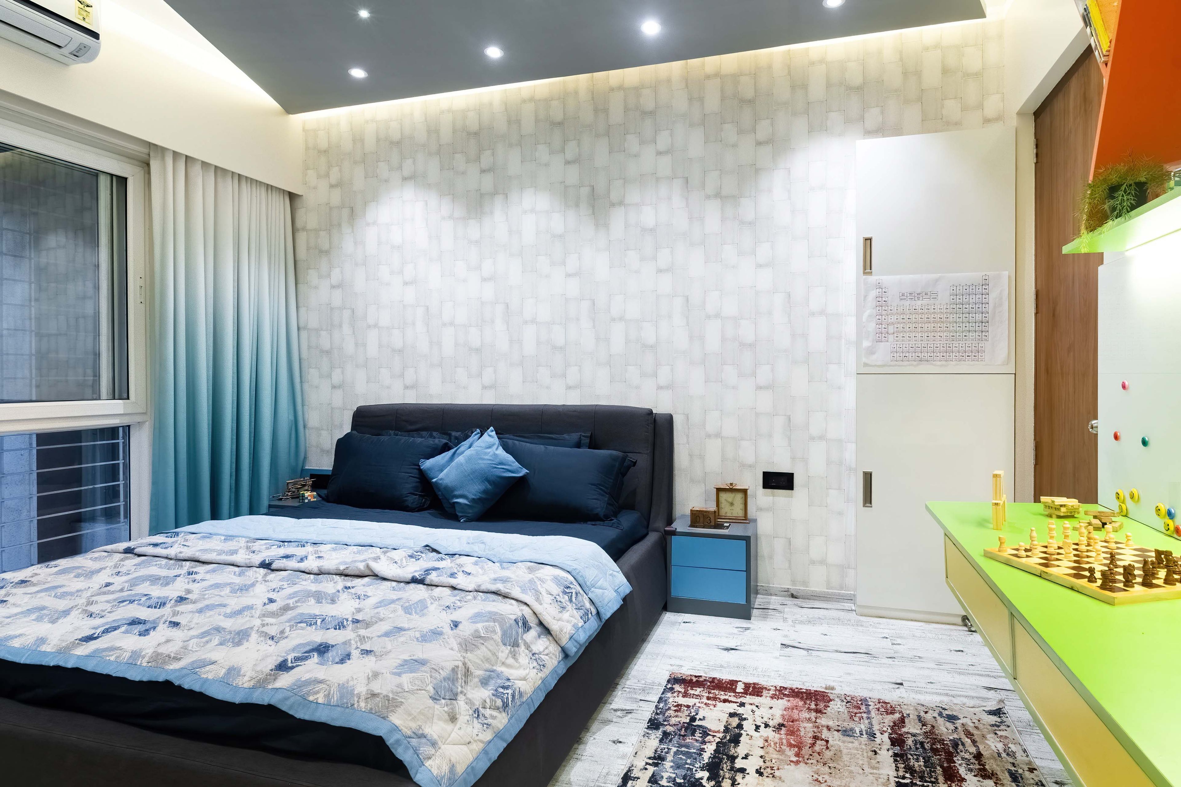 Kids room with dark blue bed and white grid accent wall