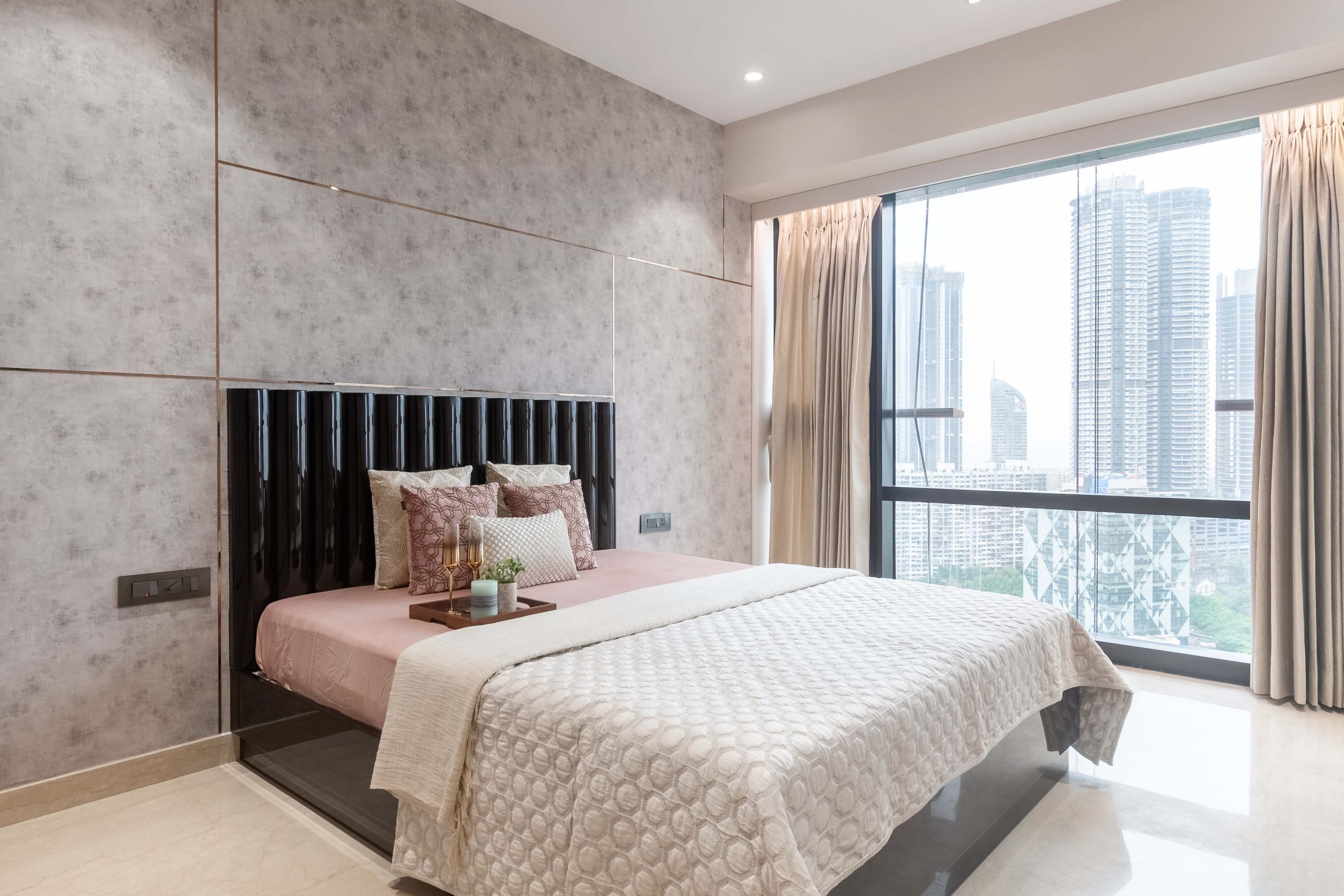 Queen-sized bed for master bedroom with black panelled headboard - Livspace