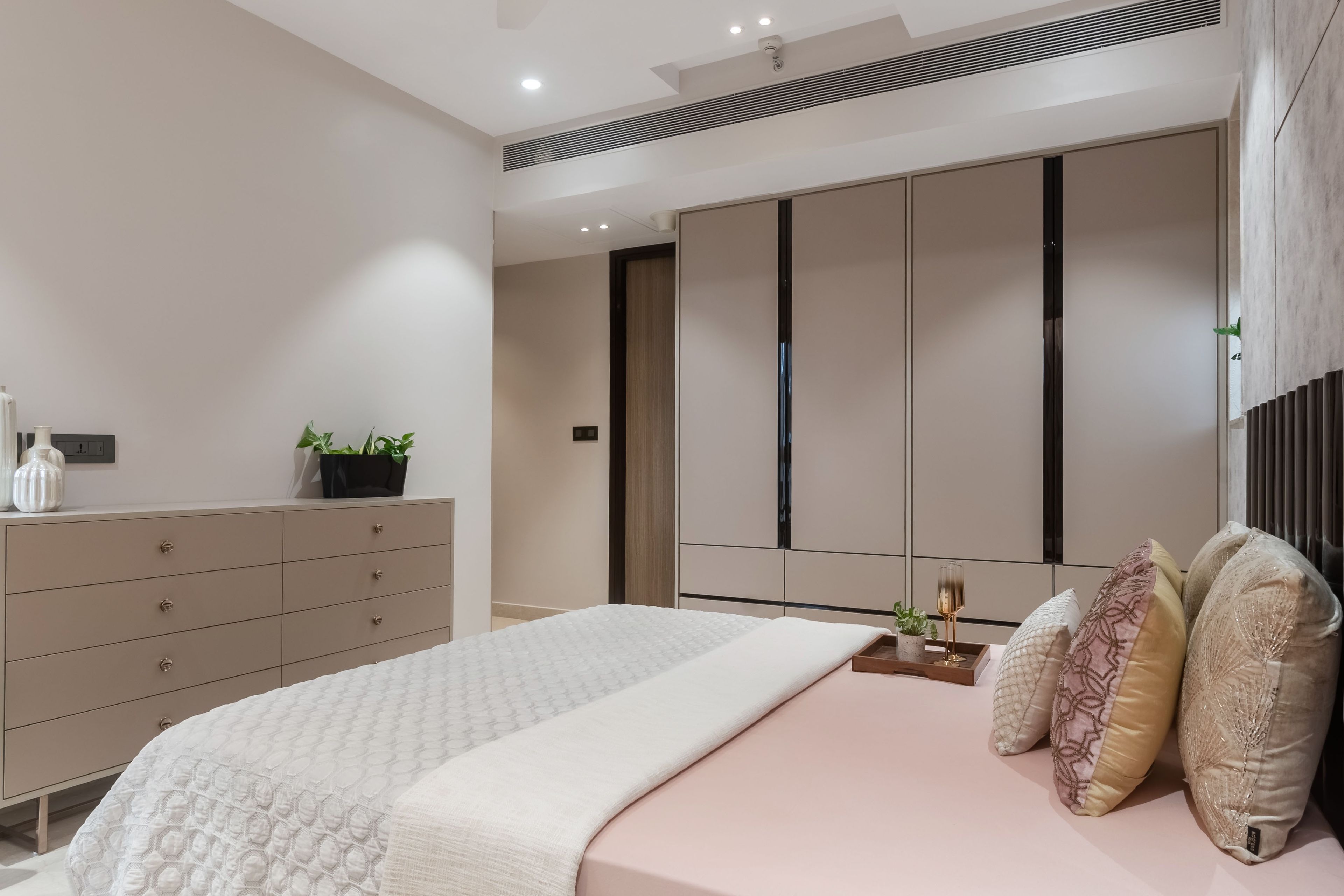 4-door light pink and black swing wardrobe with drawer storage - Livspace