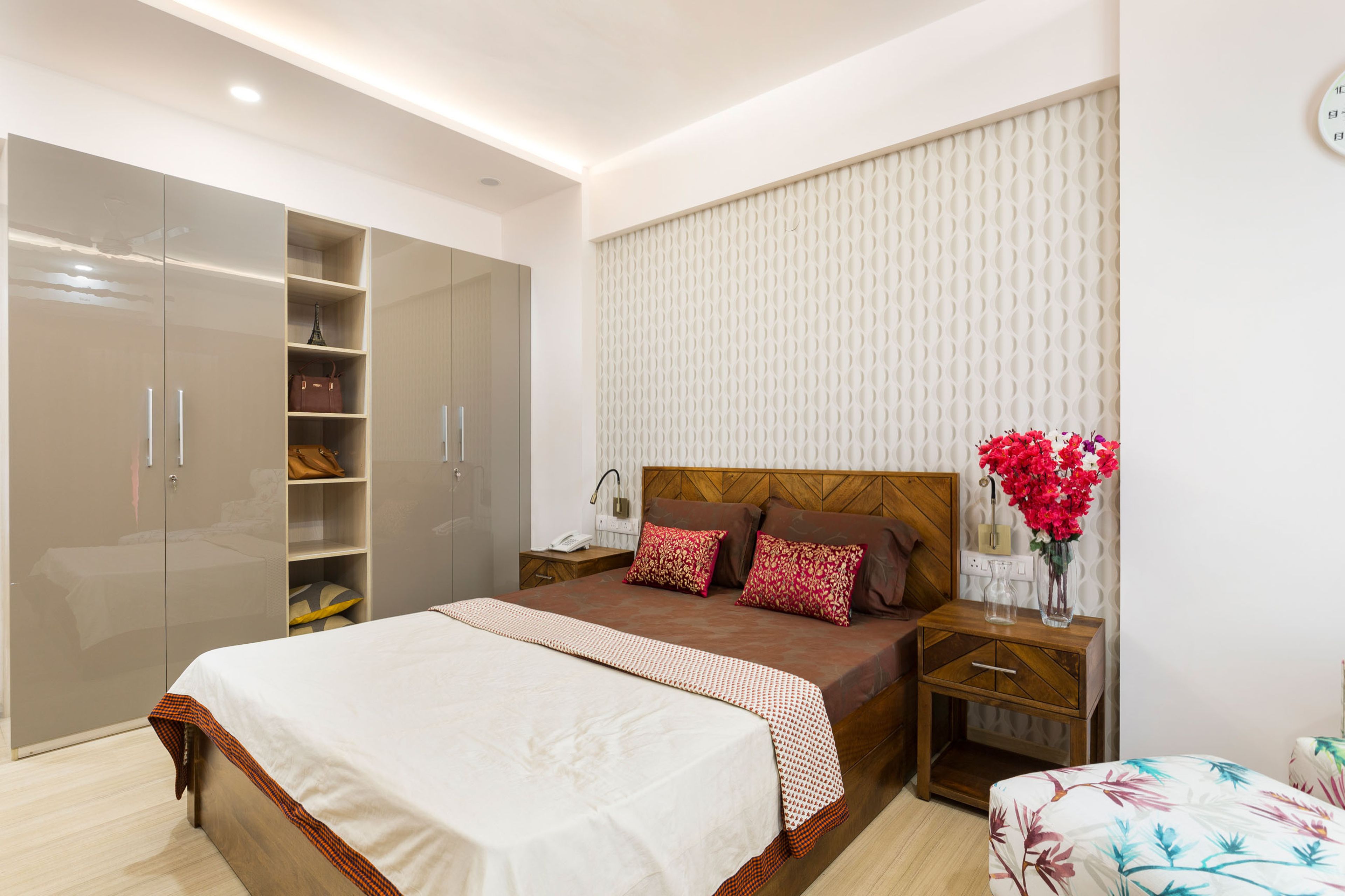 Master bedroom with wooden bed and light brown glossy wardrobe - Livspace