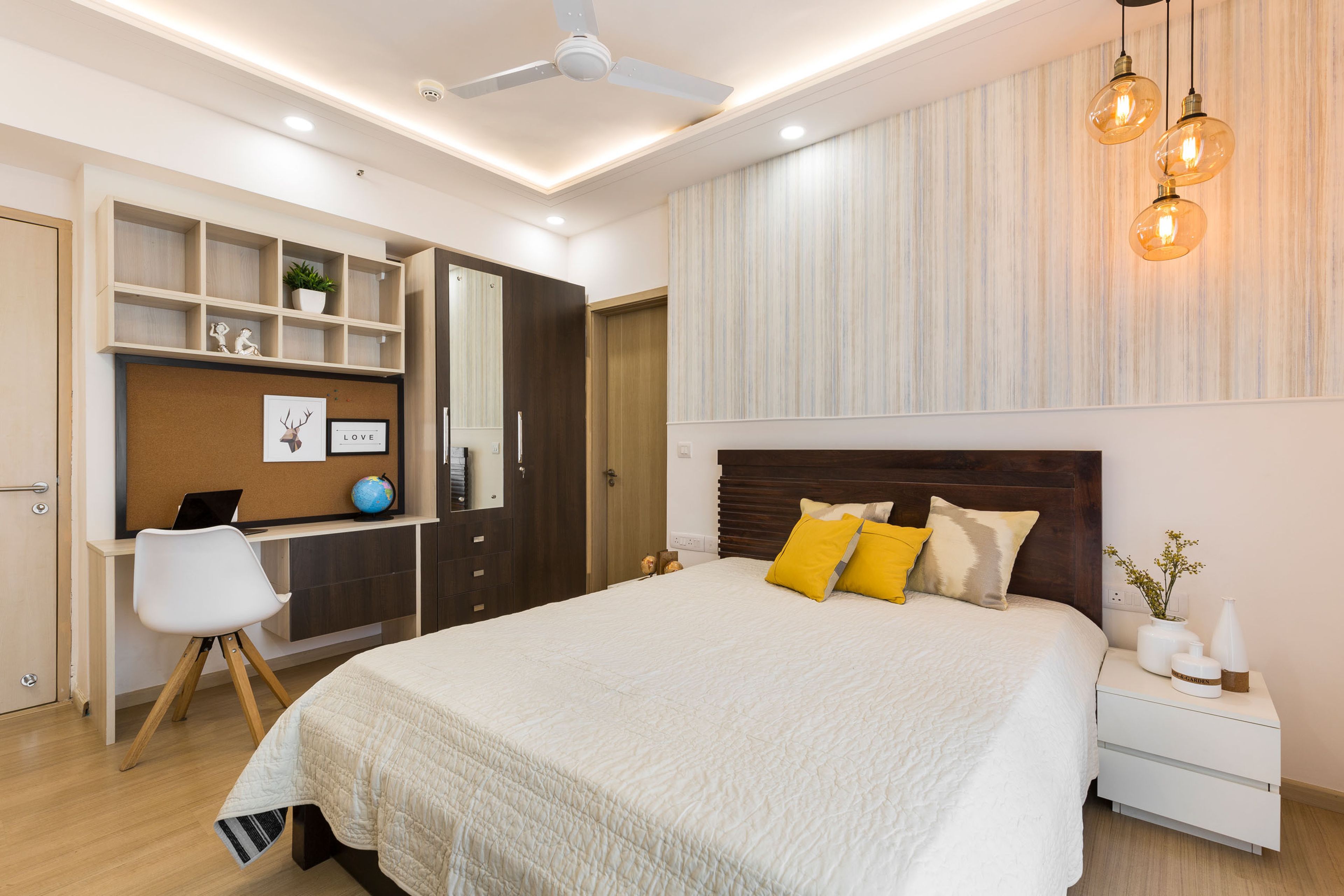 Kids room with dark wood wardrobe and integrated study table - Livspace