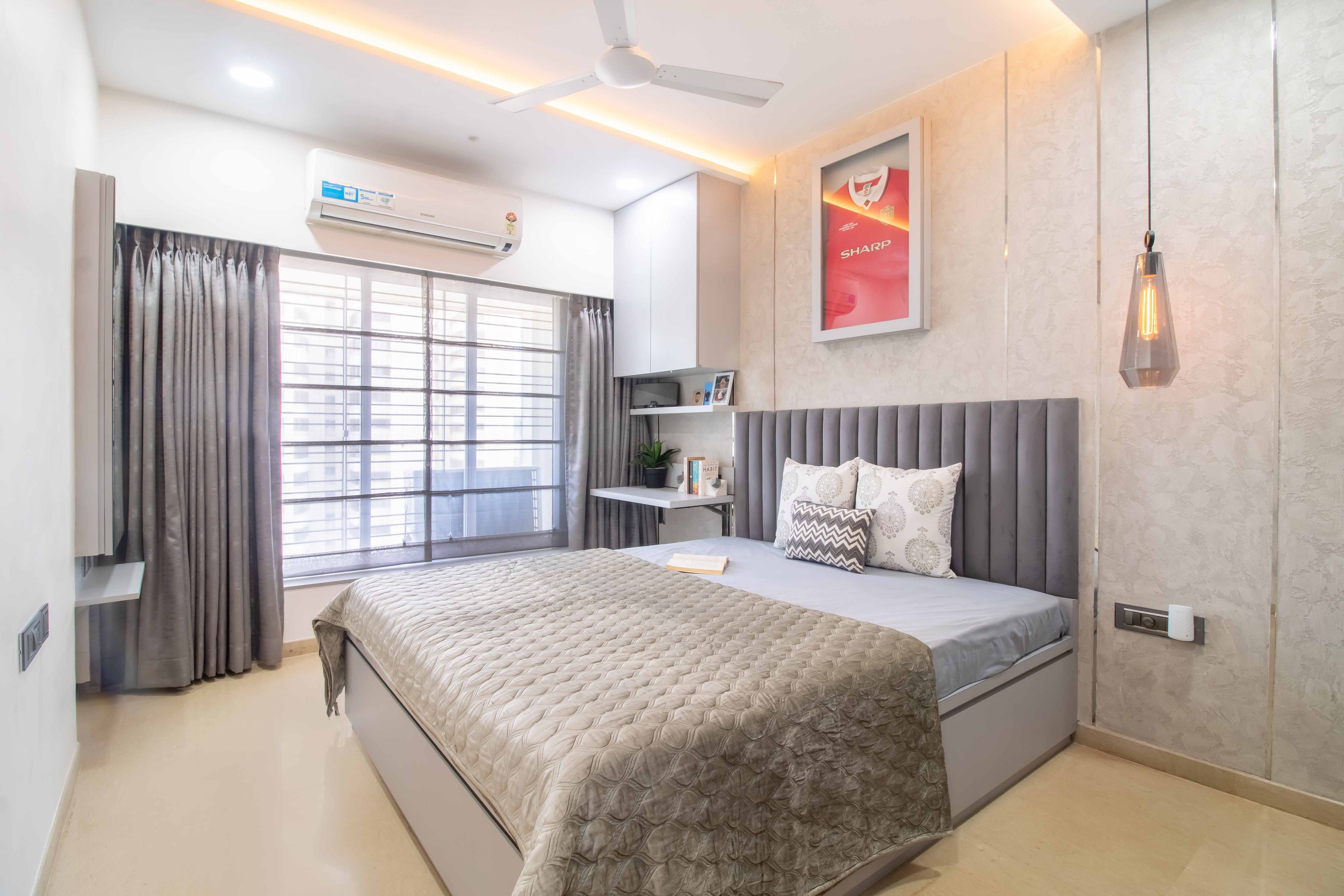 Master bedroom with grey tufted headboard - Livspace