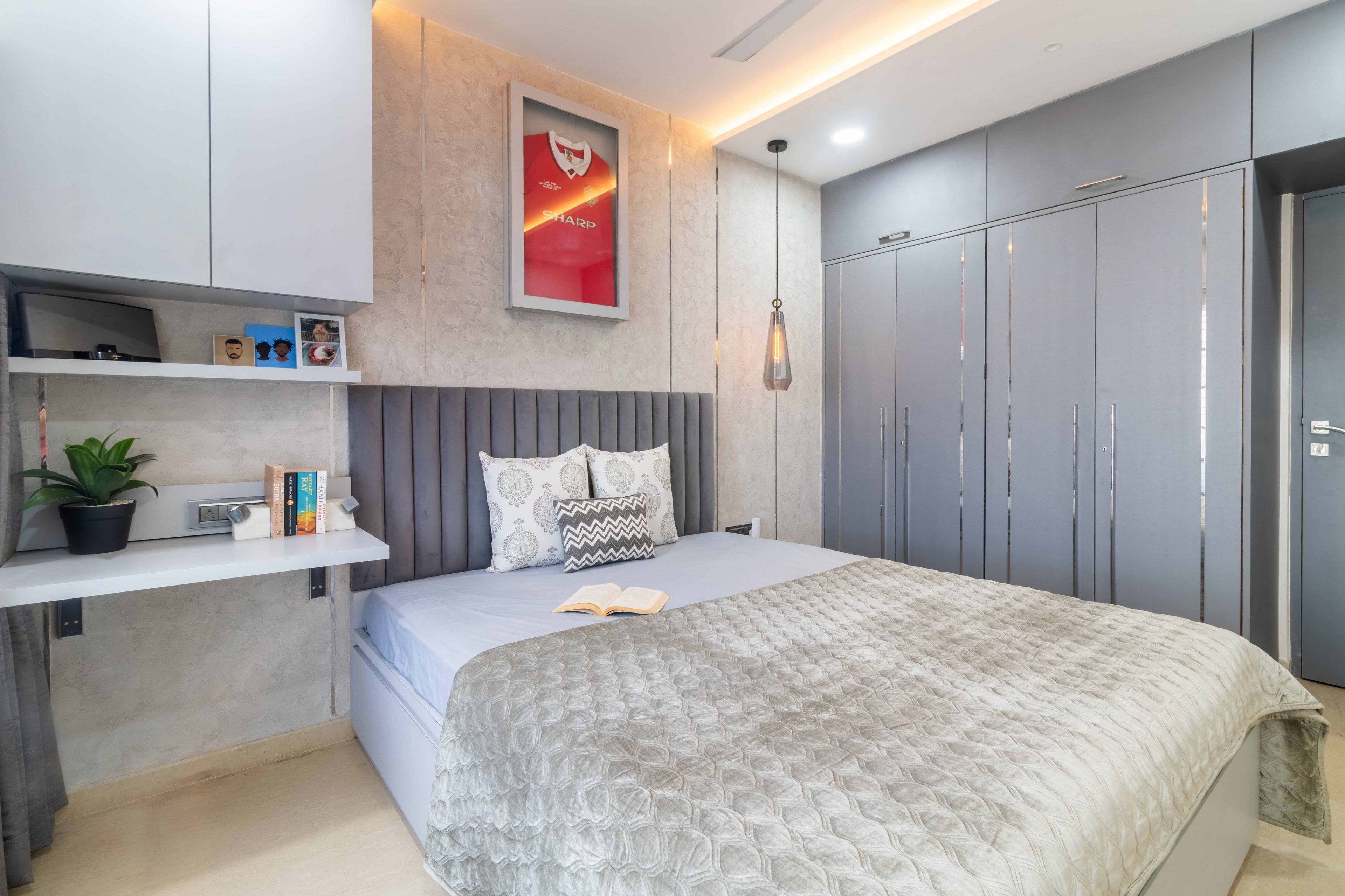 Master bedroom with 4-door swing wardrobe and loft - Livspace