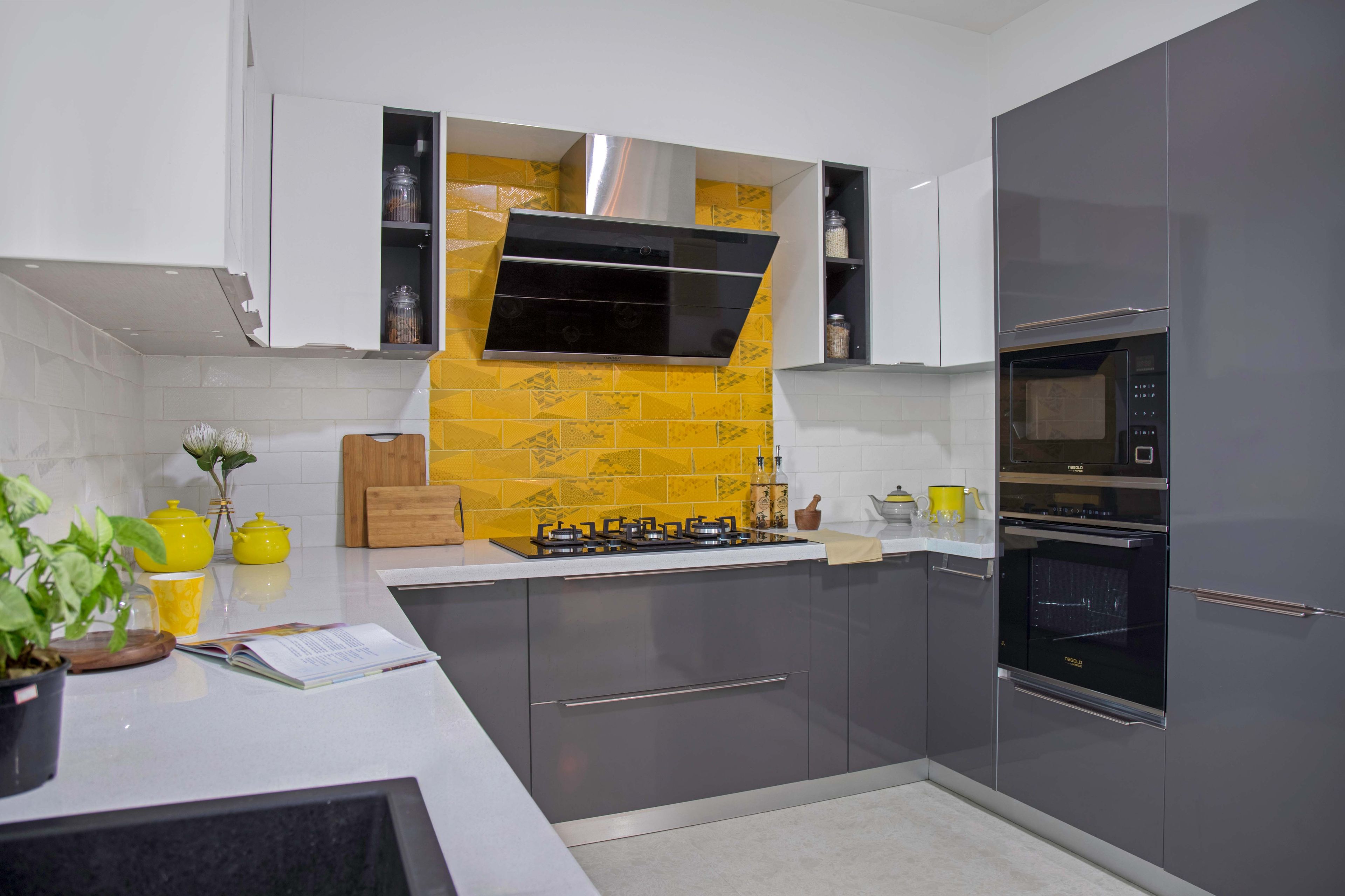 U-shaped grey and white kitchen with white and yellow dado tiles - Livspace