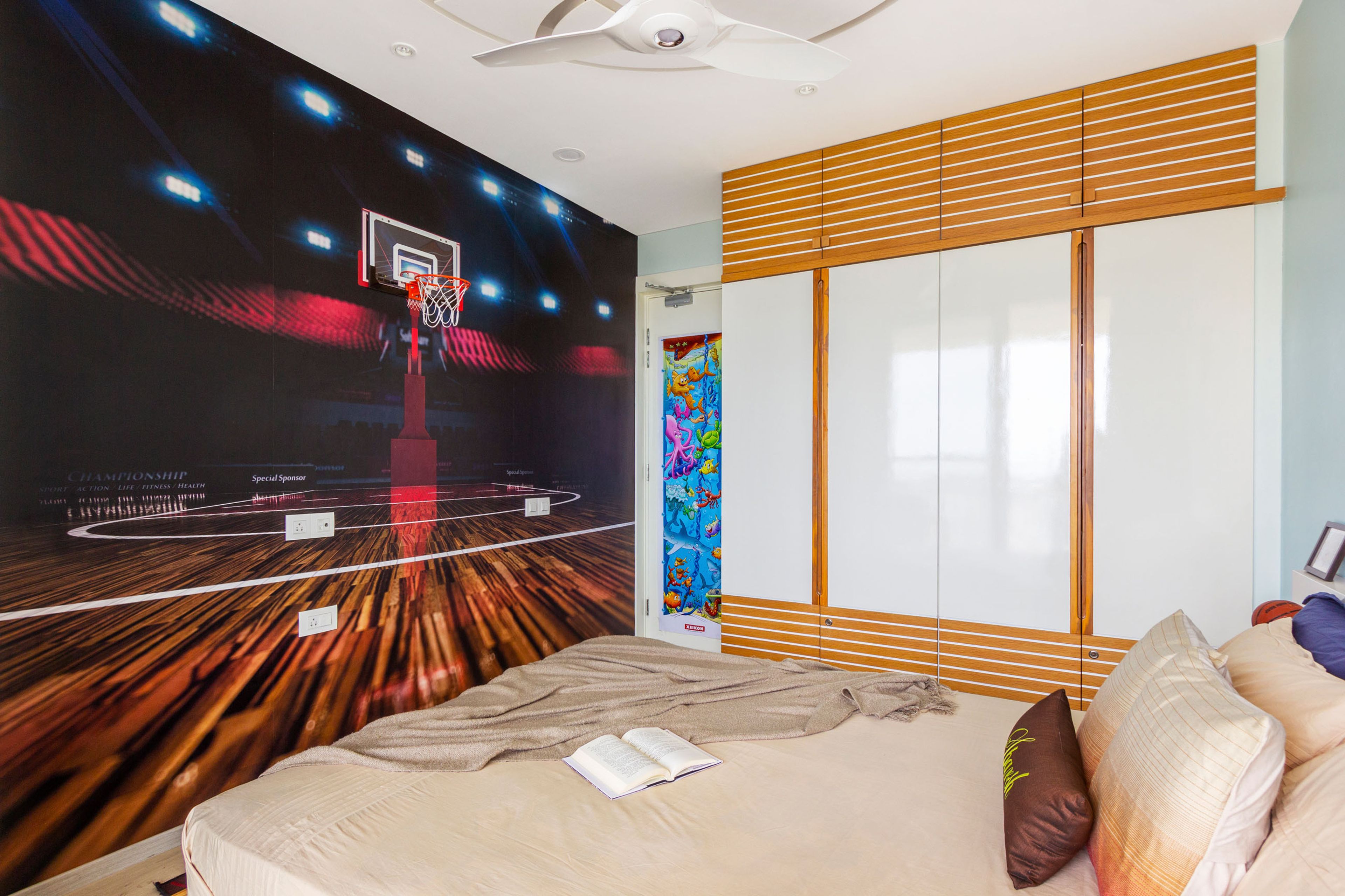Kids room with basketball court wallpaper design and wall-mounted basketball ring- Livspace