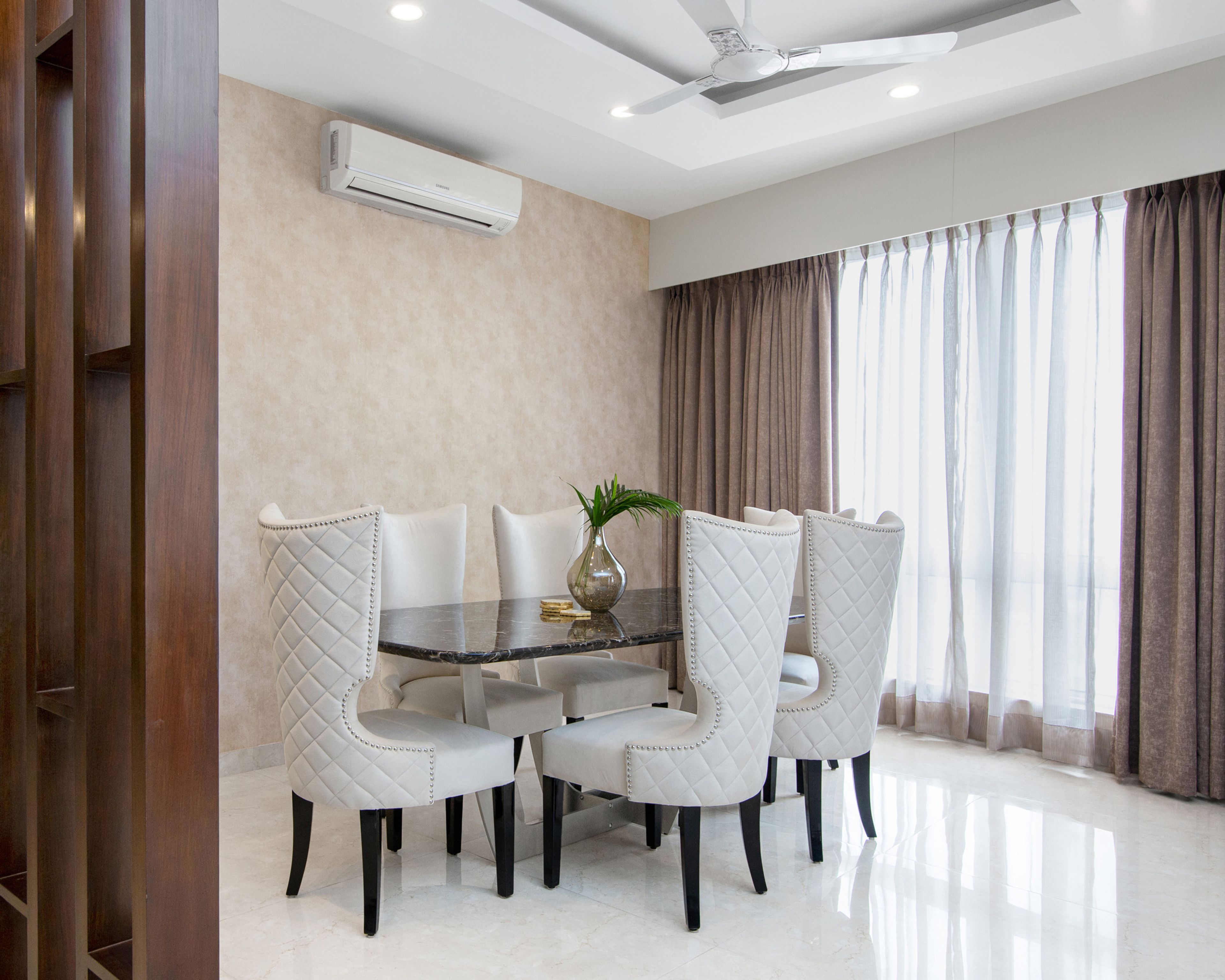 6-seater dining room with 6 white high chairs - Livspace