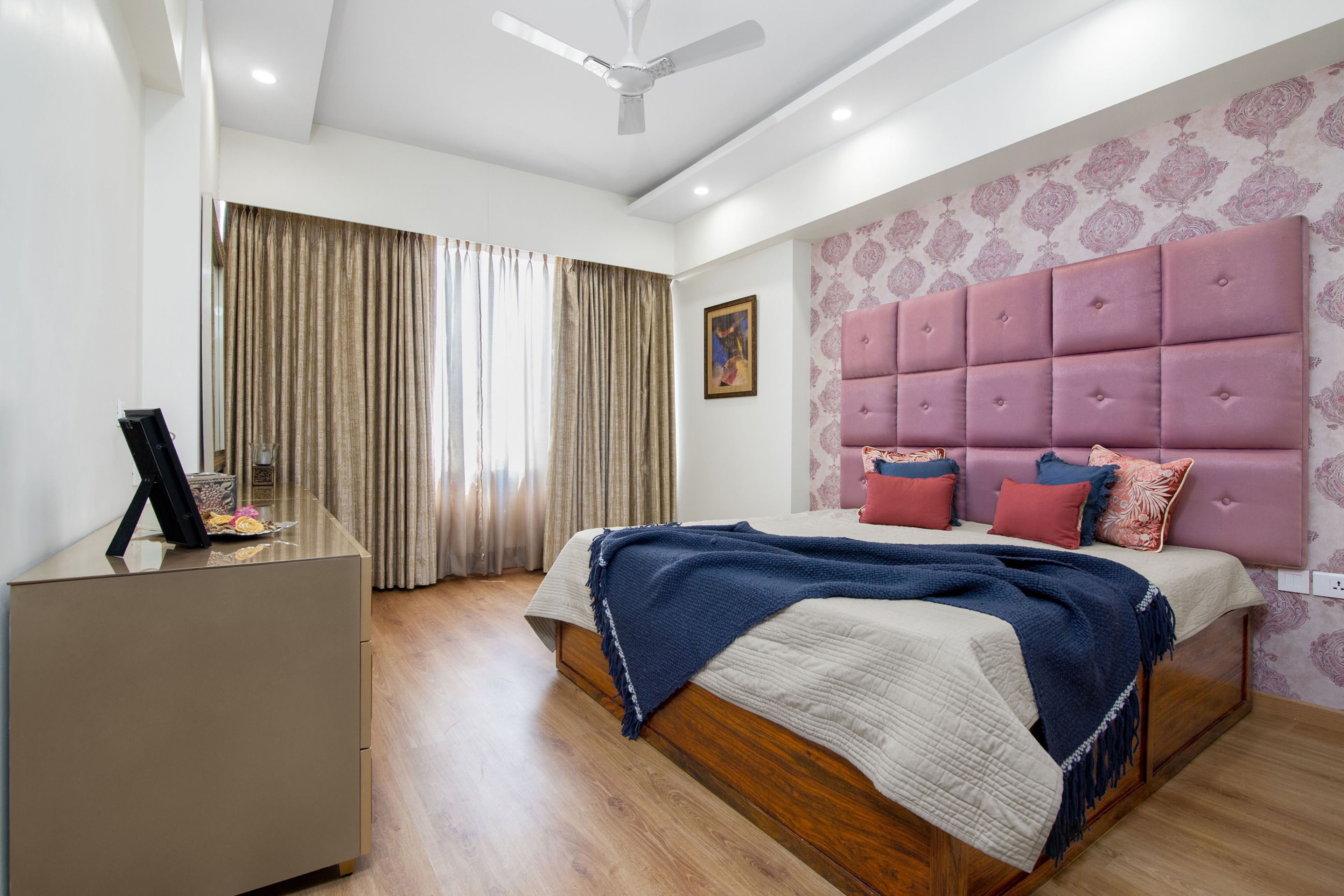 Pink guest room design with white and pink damask wallpaper - Livspace