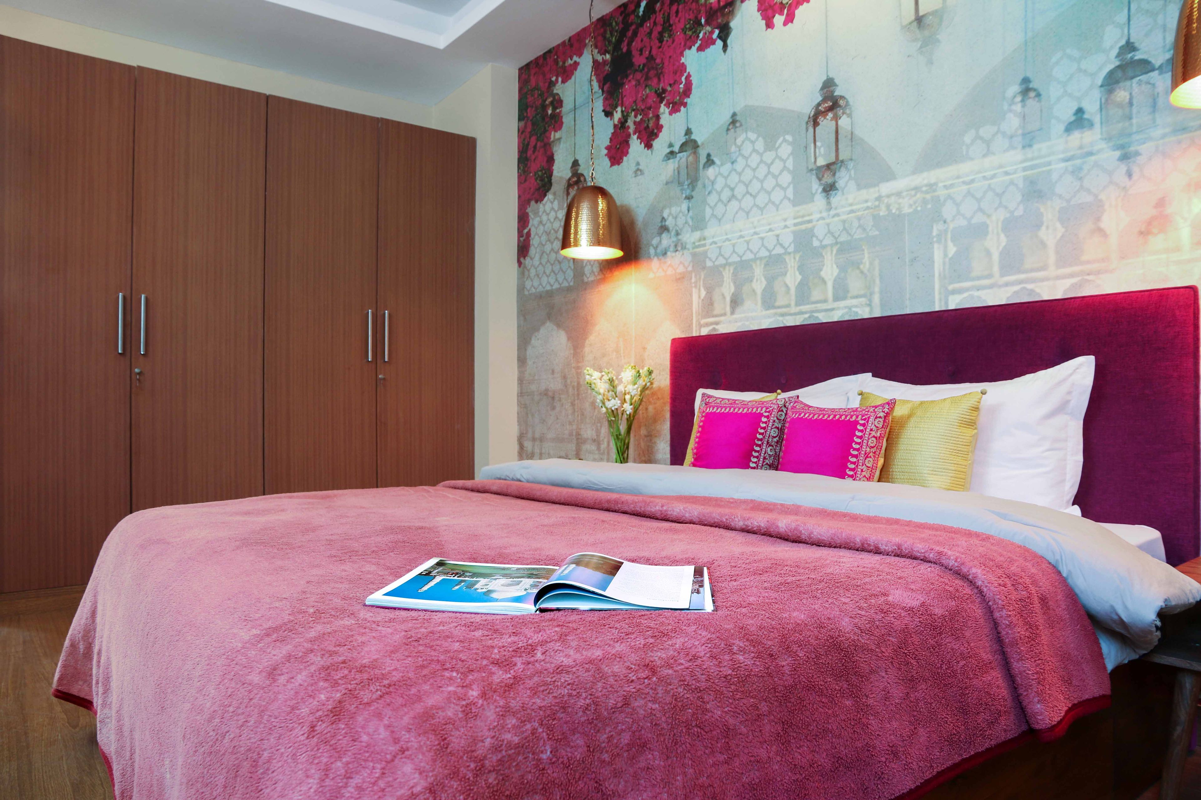 Master bedroom with 4-door woden swing wardrobe - Livspace