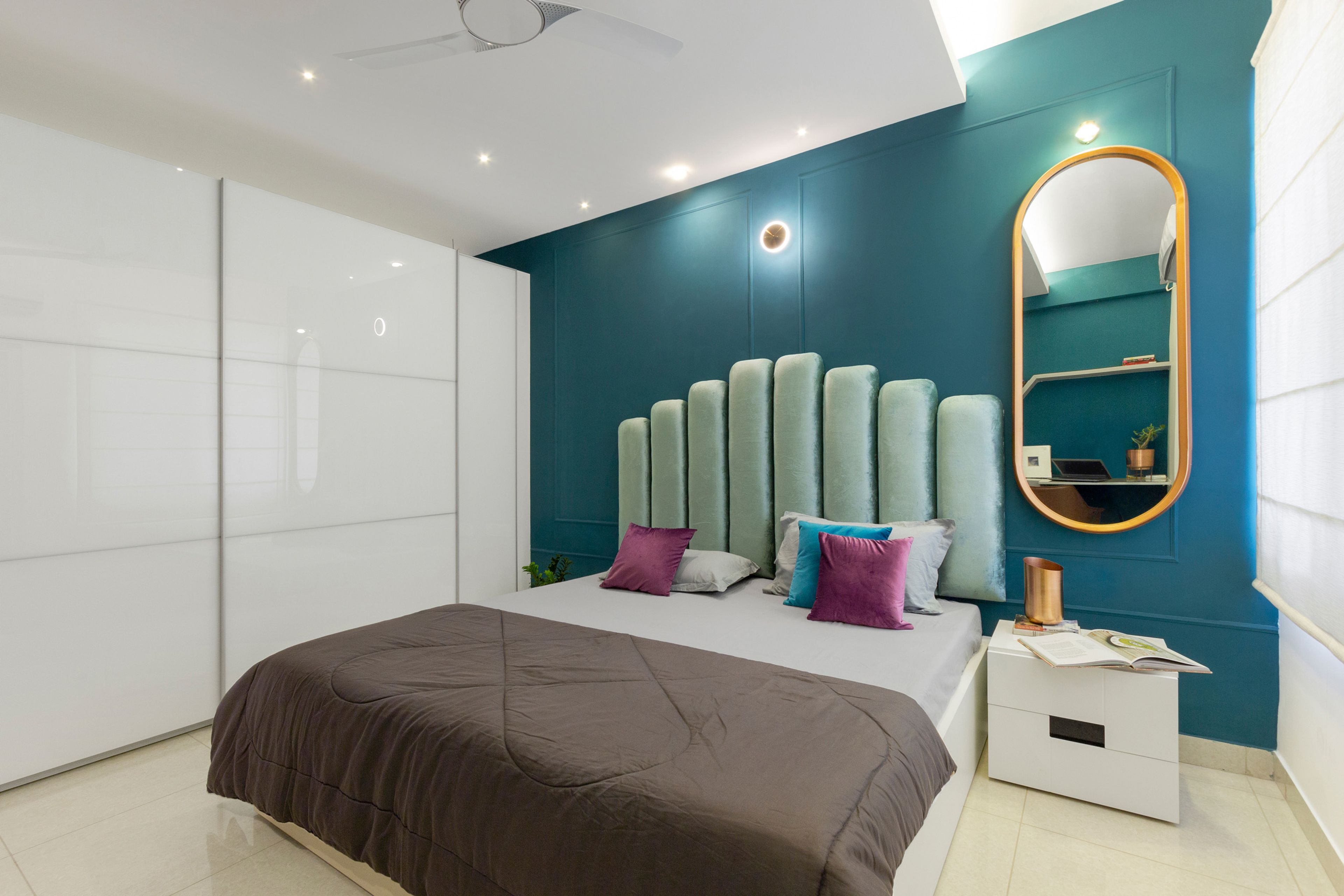 Teal blue and white master bedroom with queen sized bed and bar graph sea-green headboard - Livspace