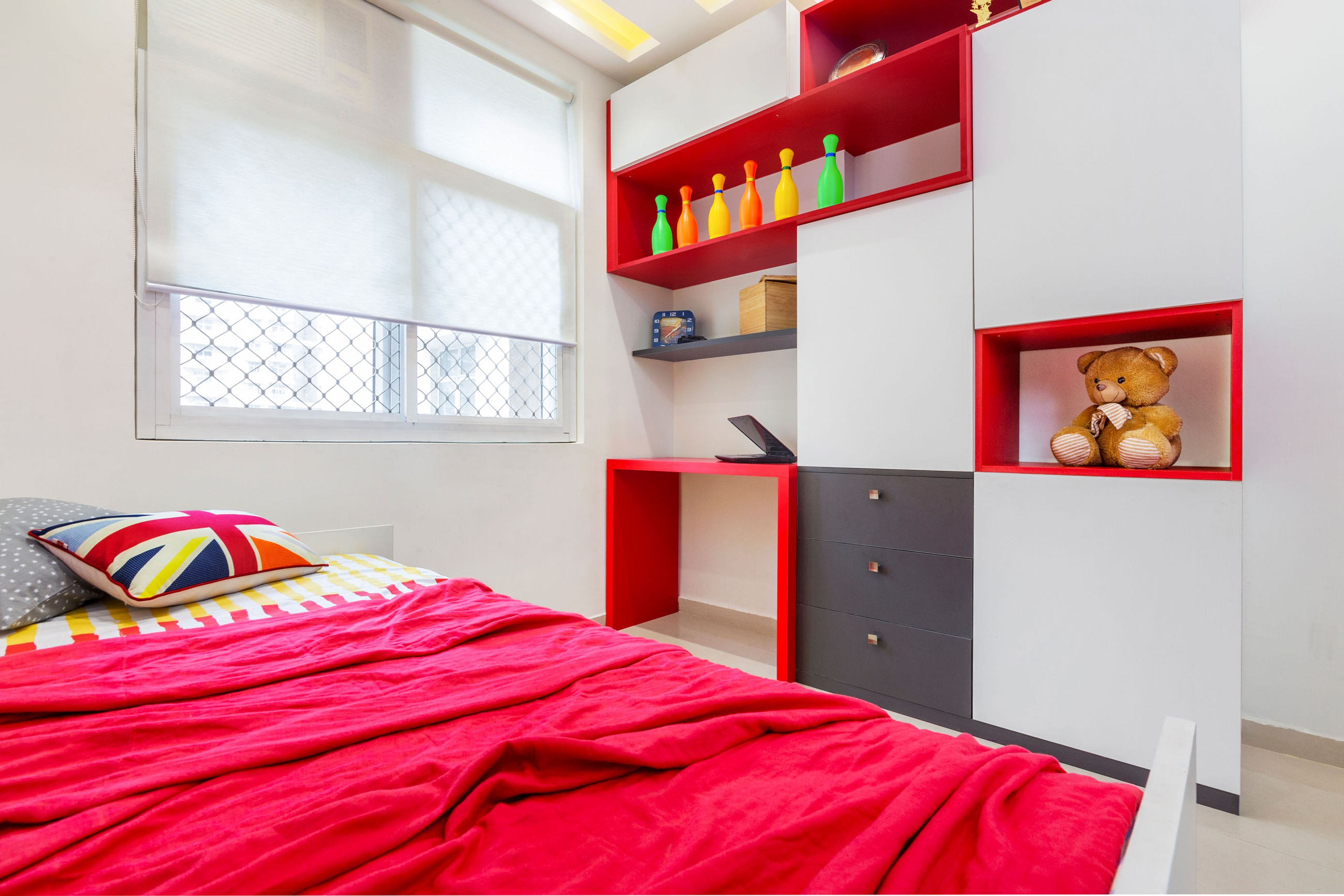 Blue and white guest bedroom with brown headboard - Livspace