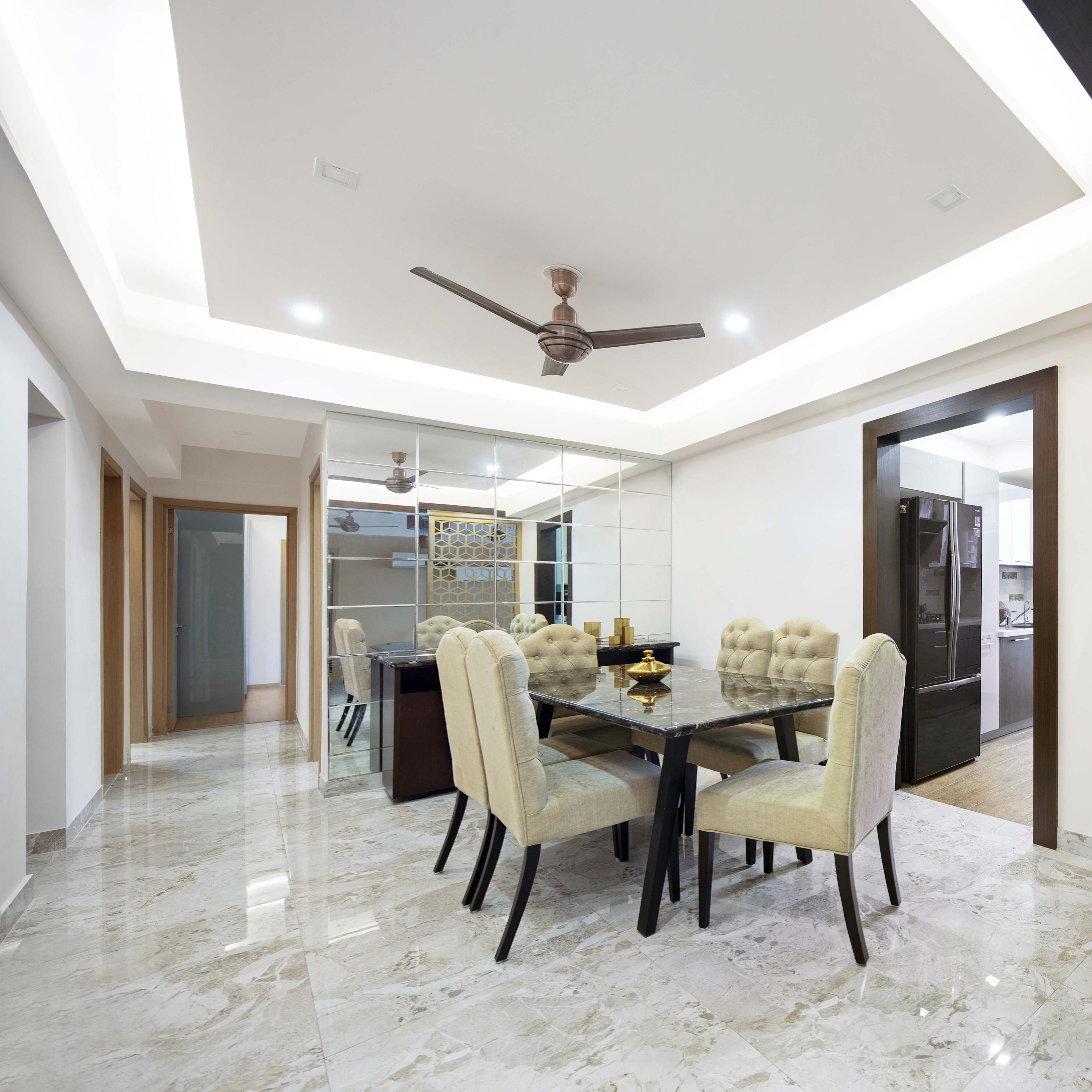 6-seater dining table with beige chairs and mirrored wall - Livspace