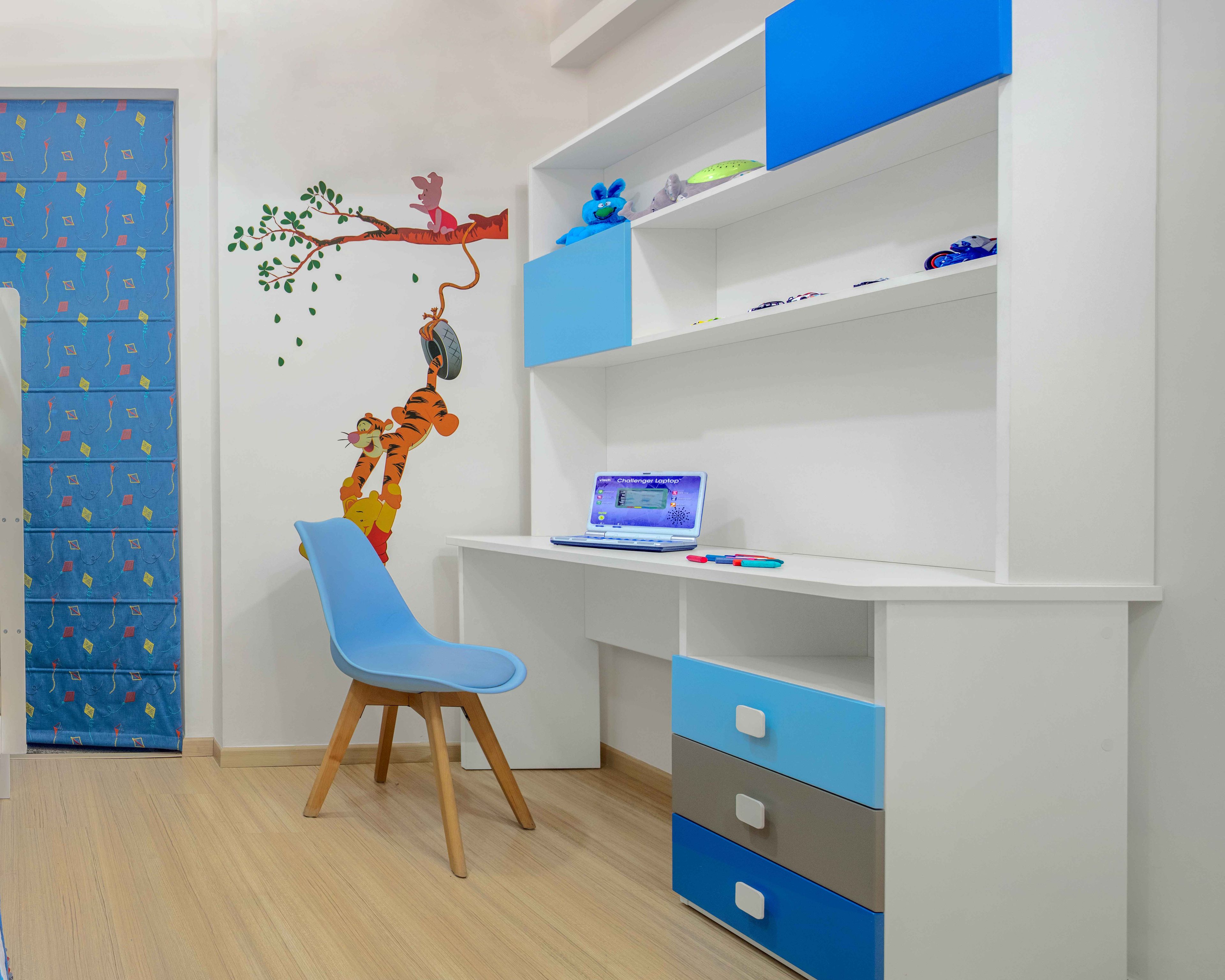Blue and white study table for kids room with open and closed storage - Livspace