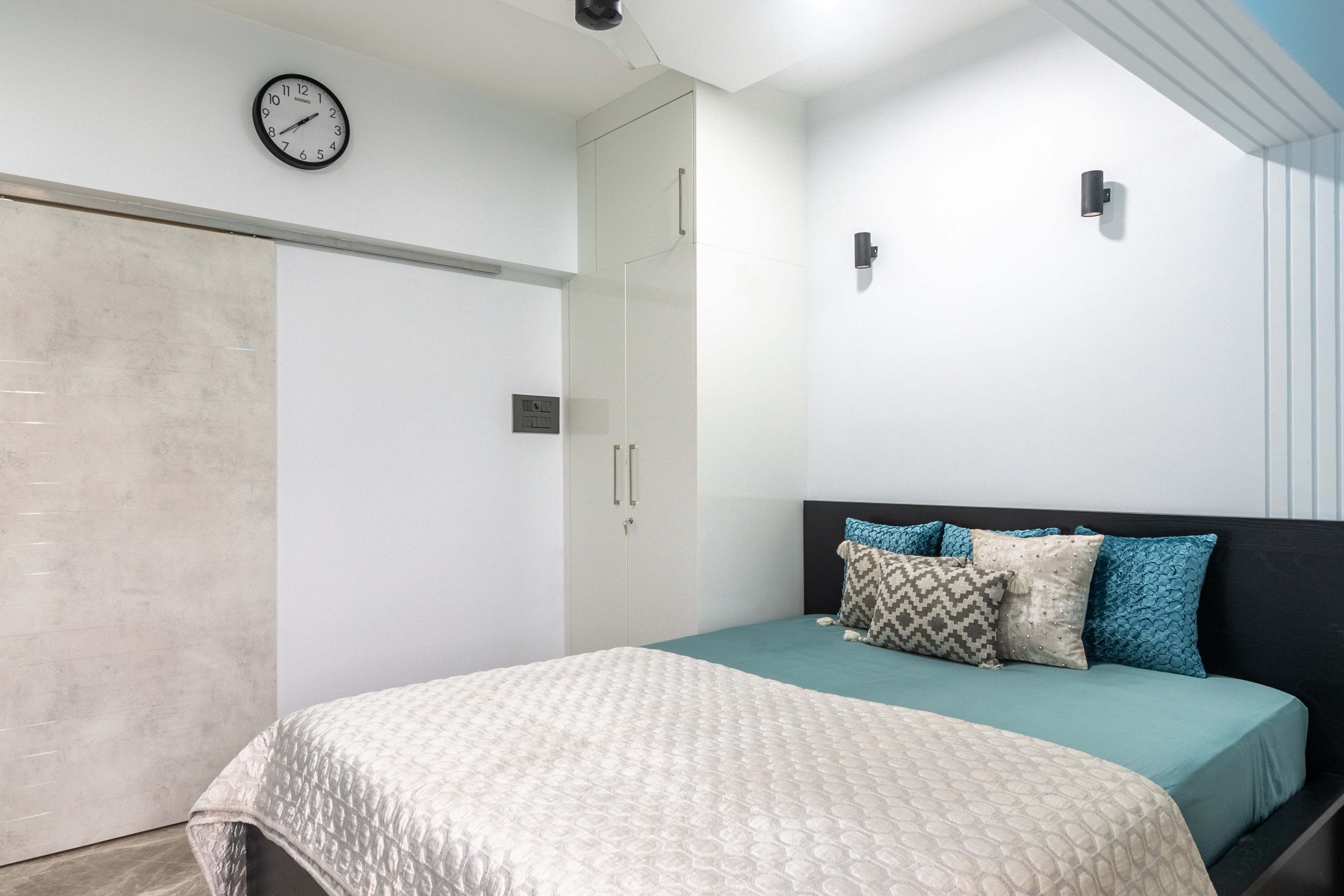 White and beige master bedroom with spotlights - Livspace