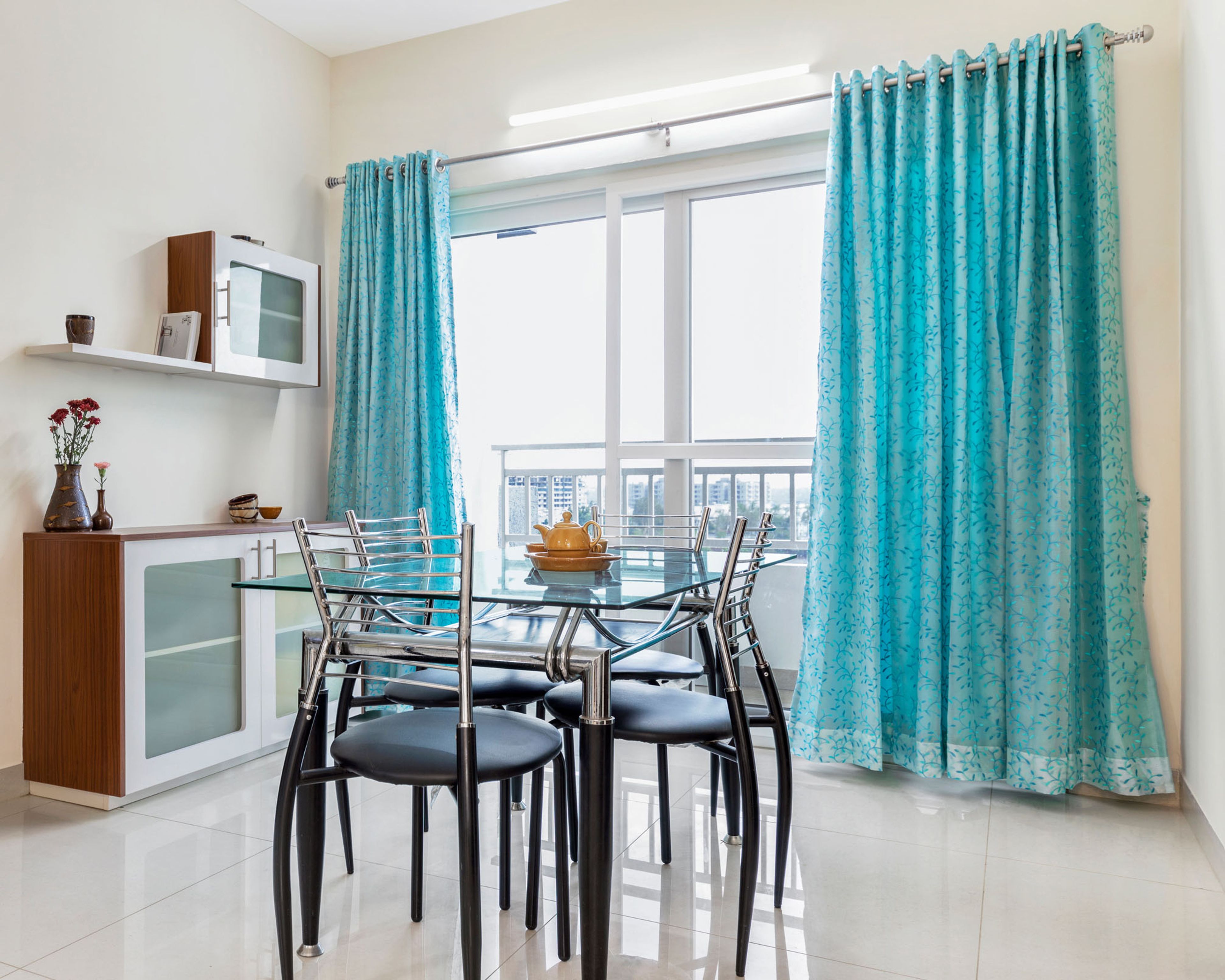 4-seater wooden dining table with wood and white storage unit - Livspace