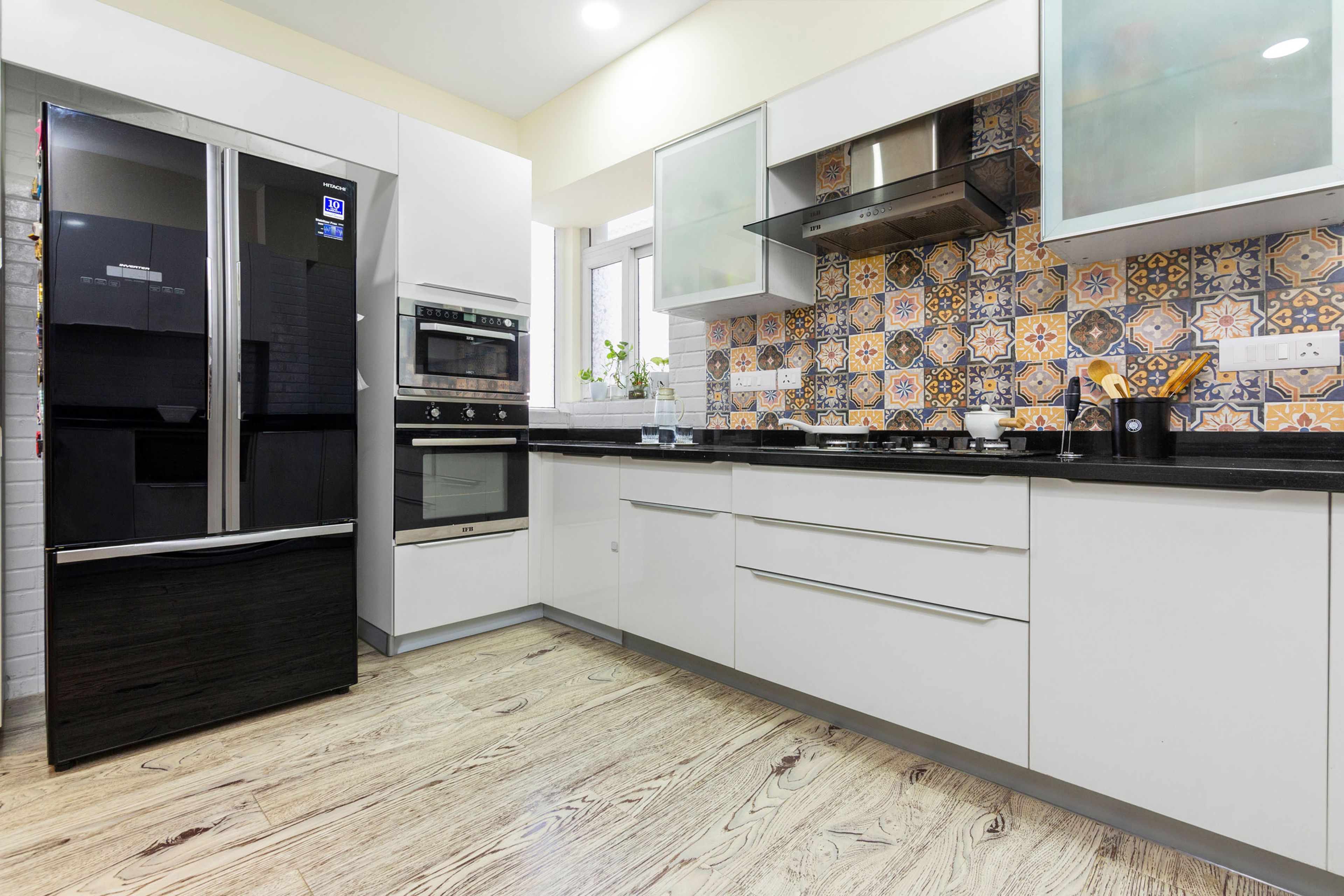 Glossy White U-Shaped Modular Kitchen Design With Granite Countertop - Livspace