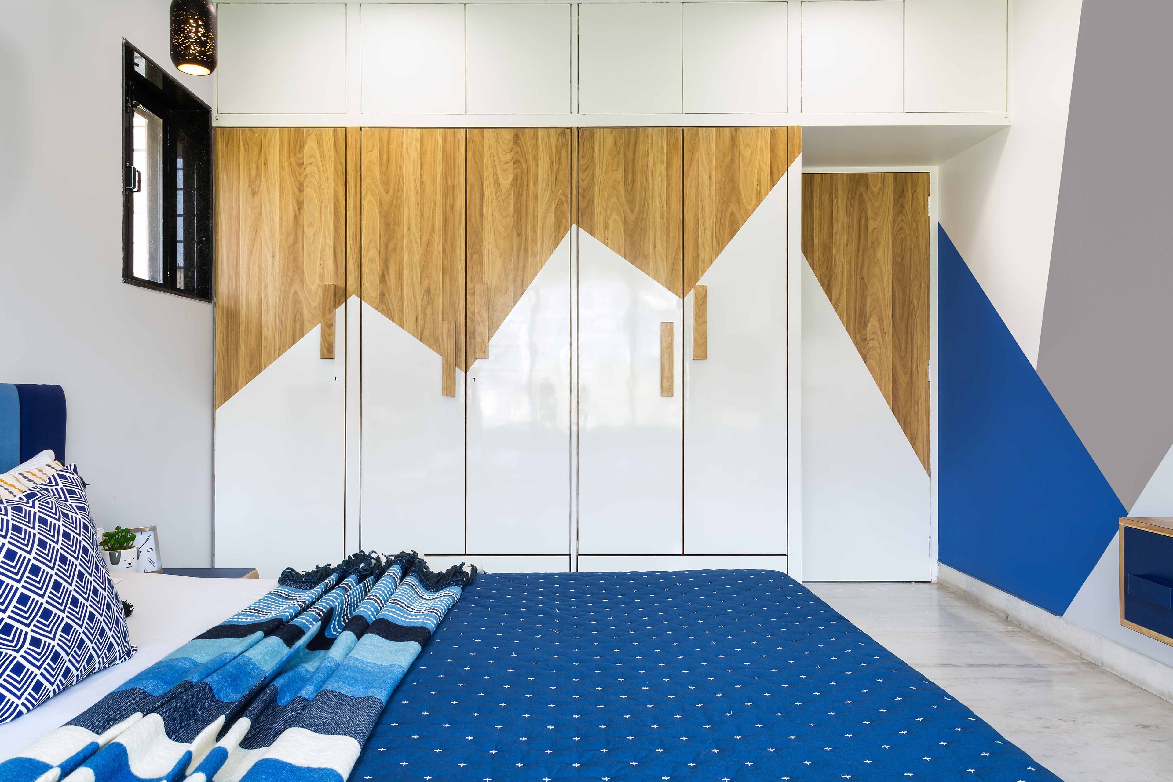 Blue And Grey Bedroom Design With White And Wood Wardrobe - Livspace