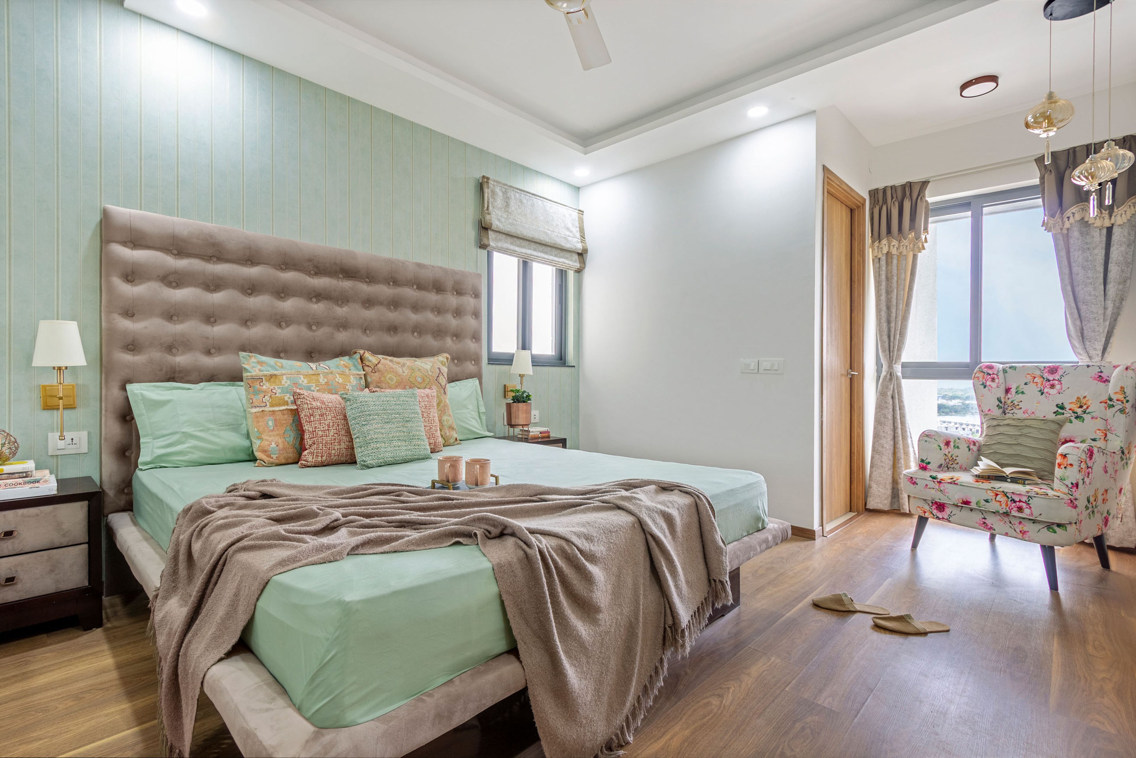 Master Bedroom Design With Light Brown Sliding Wardrobe With Mirror And Floral Accent Chair - Livspace