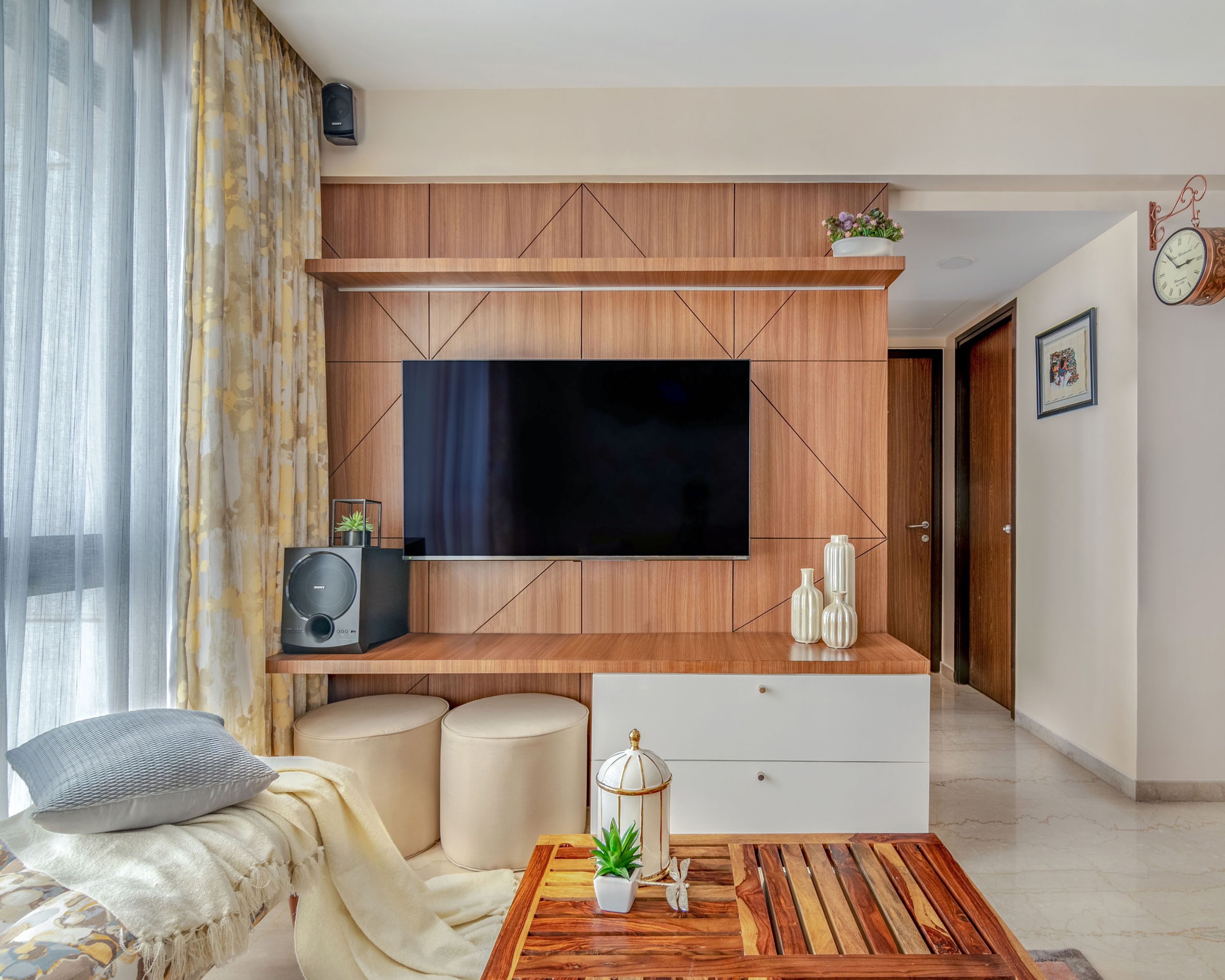 White And Walnut Bronze TV Unit Design With Wooden Paneling - Livspace