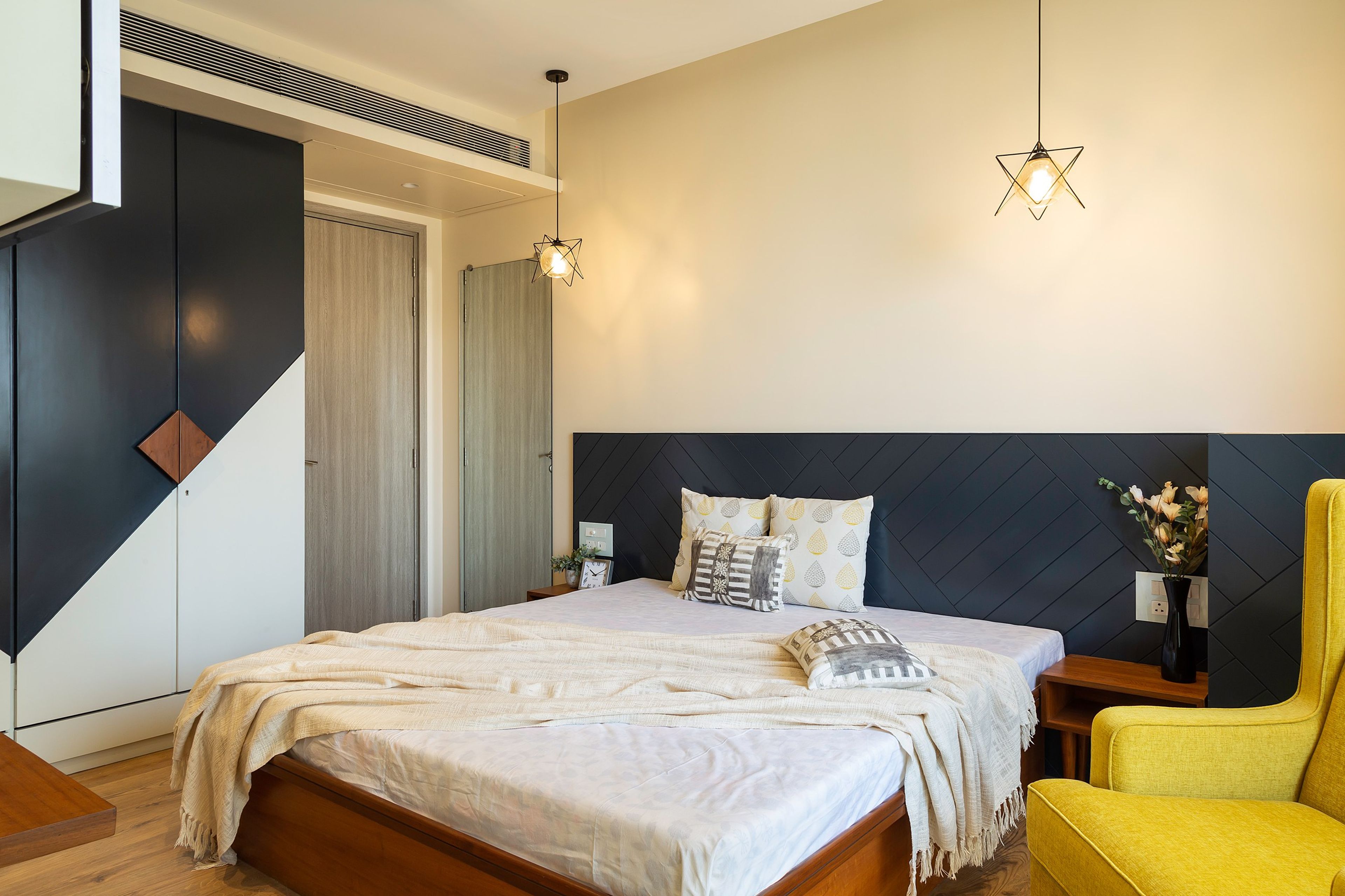 Master Bedroom Design With Dual-Tone Wall Design And Hanging Pendant Lights - Livspace