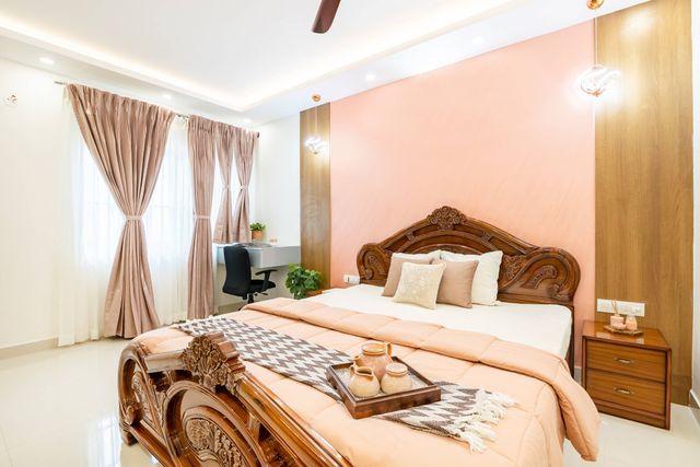 Spacious Bedroom Design With Pink Walls And Warm Hanging Lights | Livspace