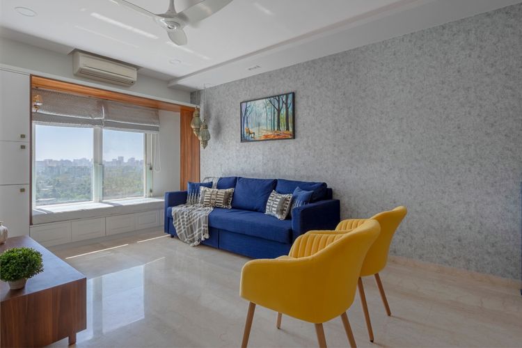 Spacious Drawing Room Design With Yellow Accent Chairs | Livspace